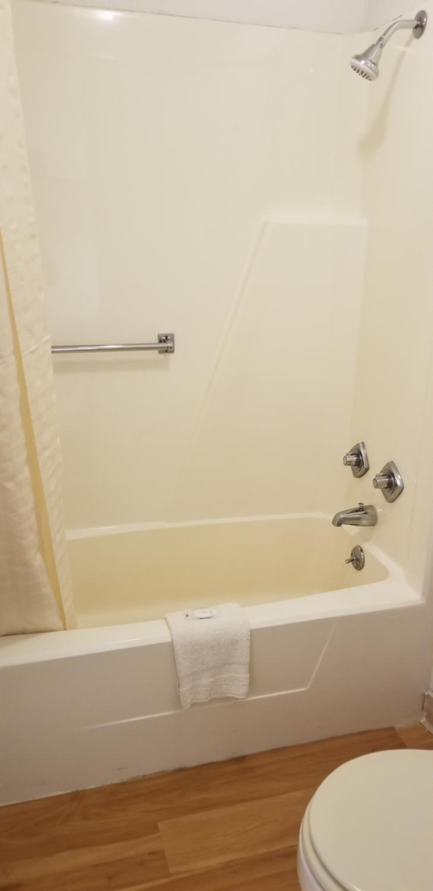 bathroom with a toilet, tub, and shower curtain