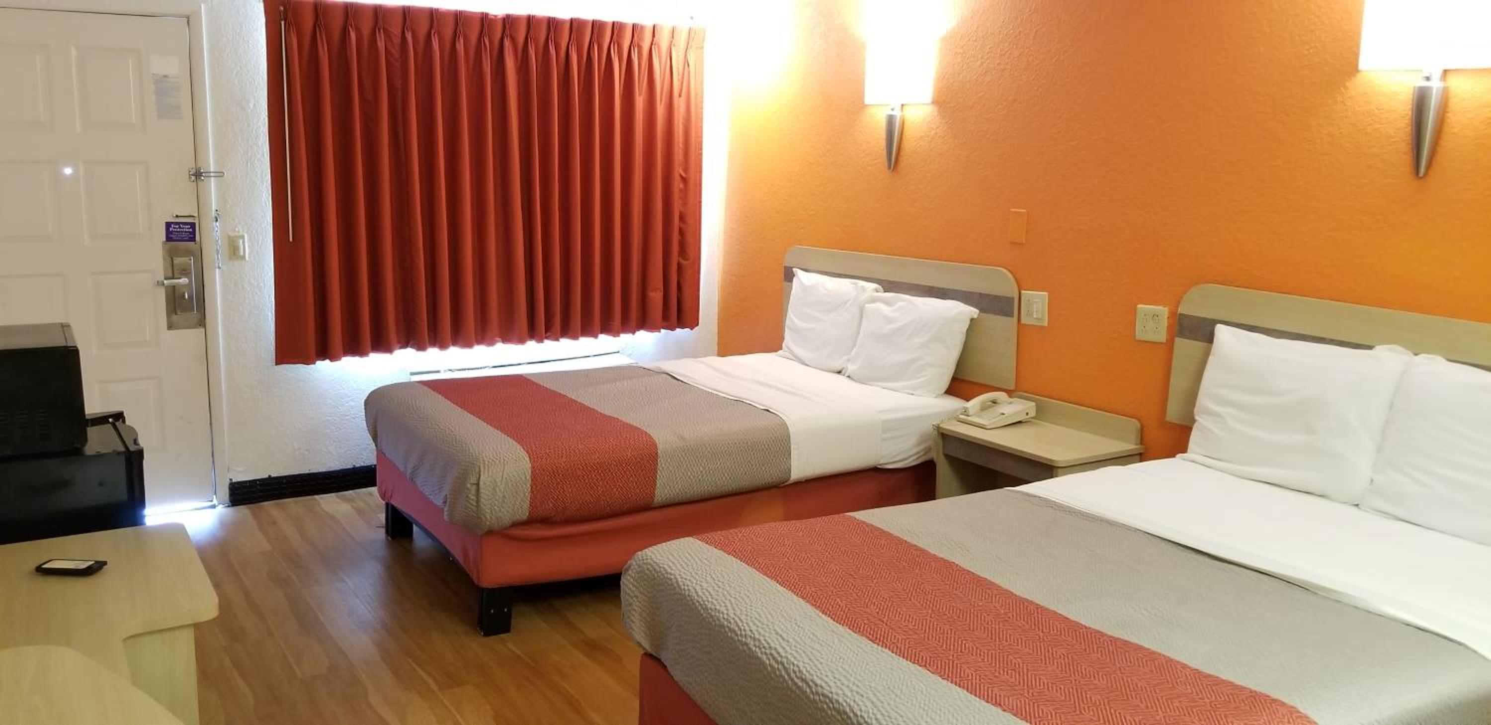 hotel room with two beds and a flat screen tv