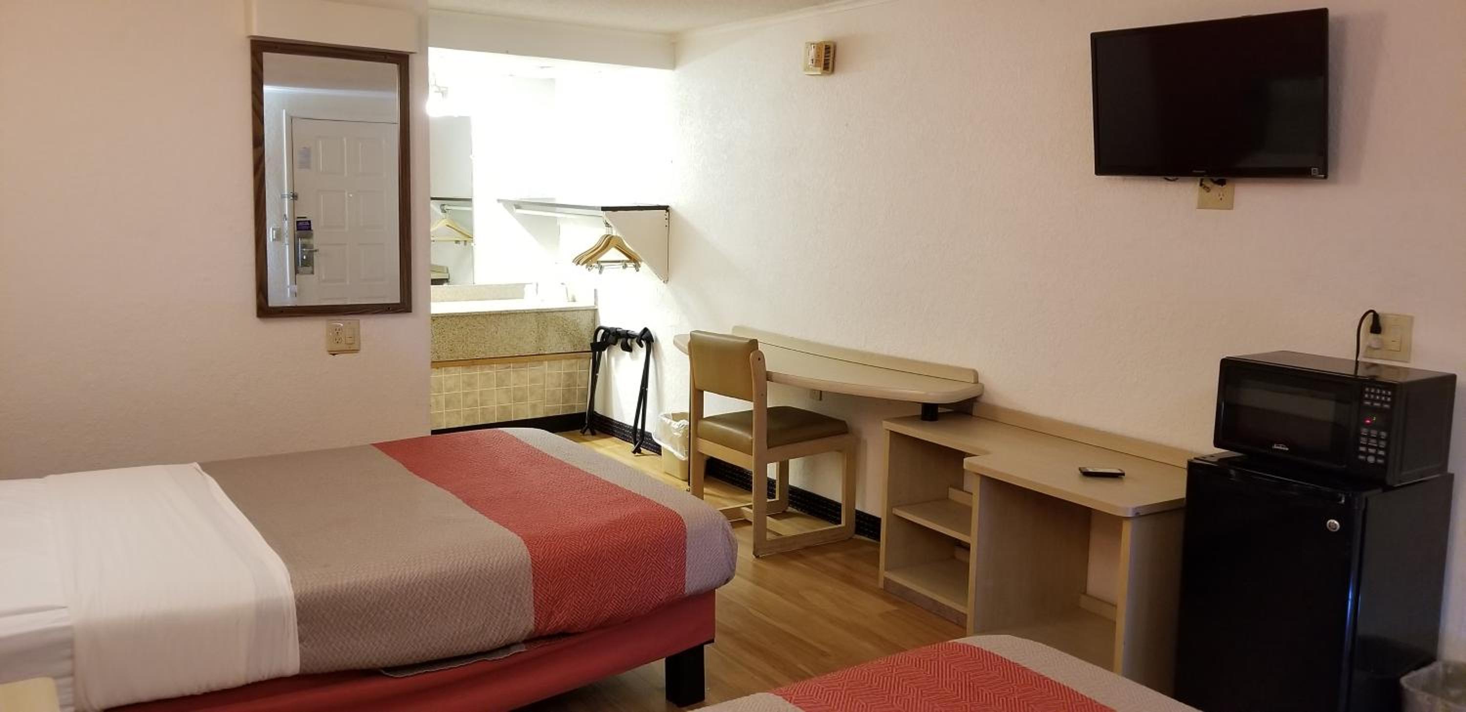 hotel room with two beds and a flat screen tv
