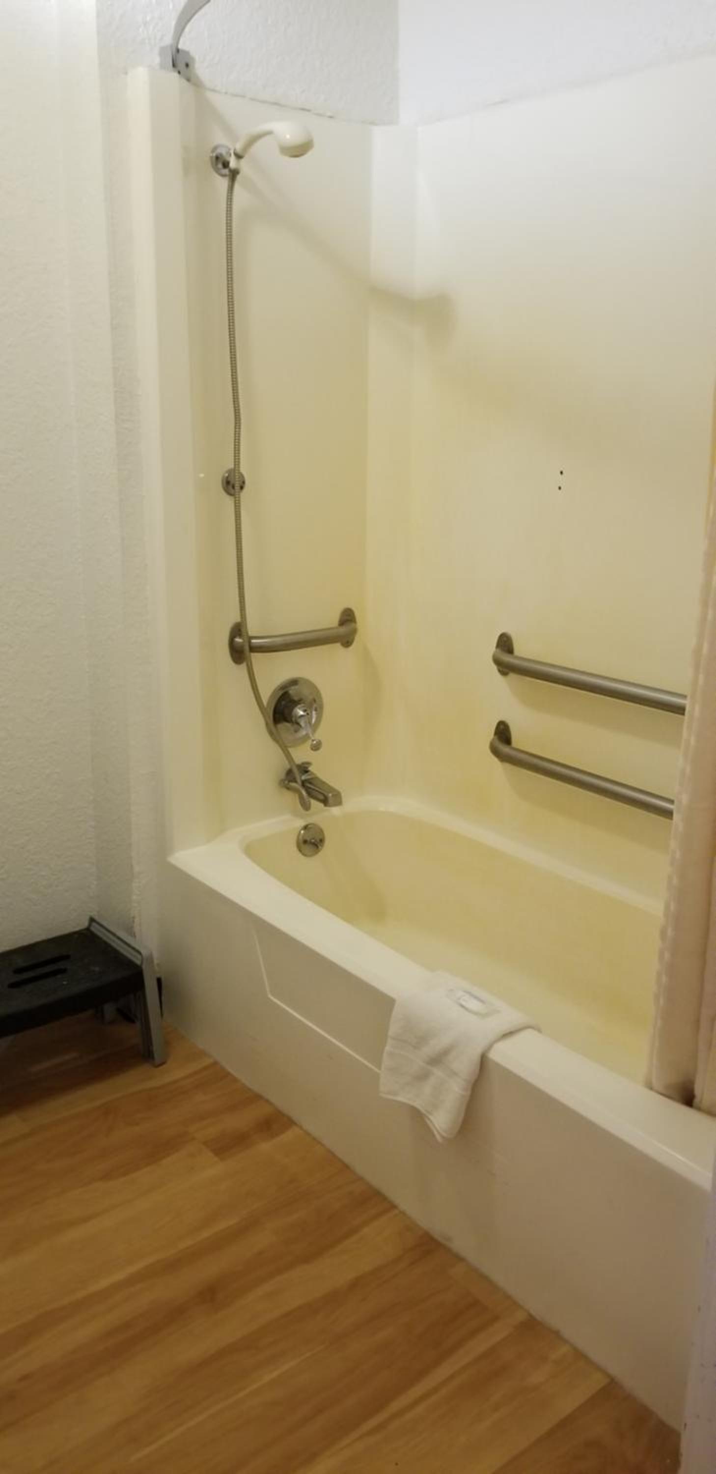 bathroom with a shower, toilet, and bathtub