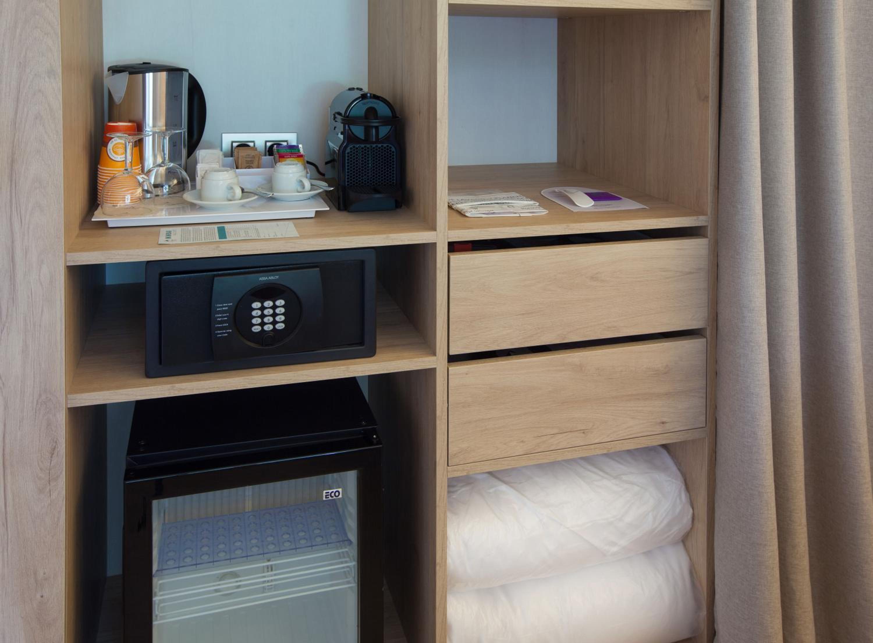 hotel room with a microwave, coffee maker and other items