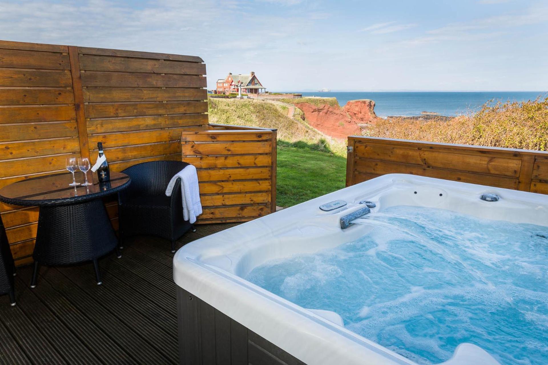 Private deck with hot tub, bistro table and sea view