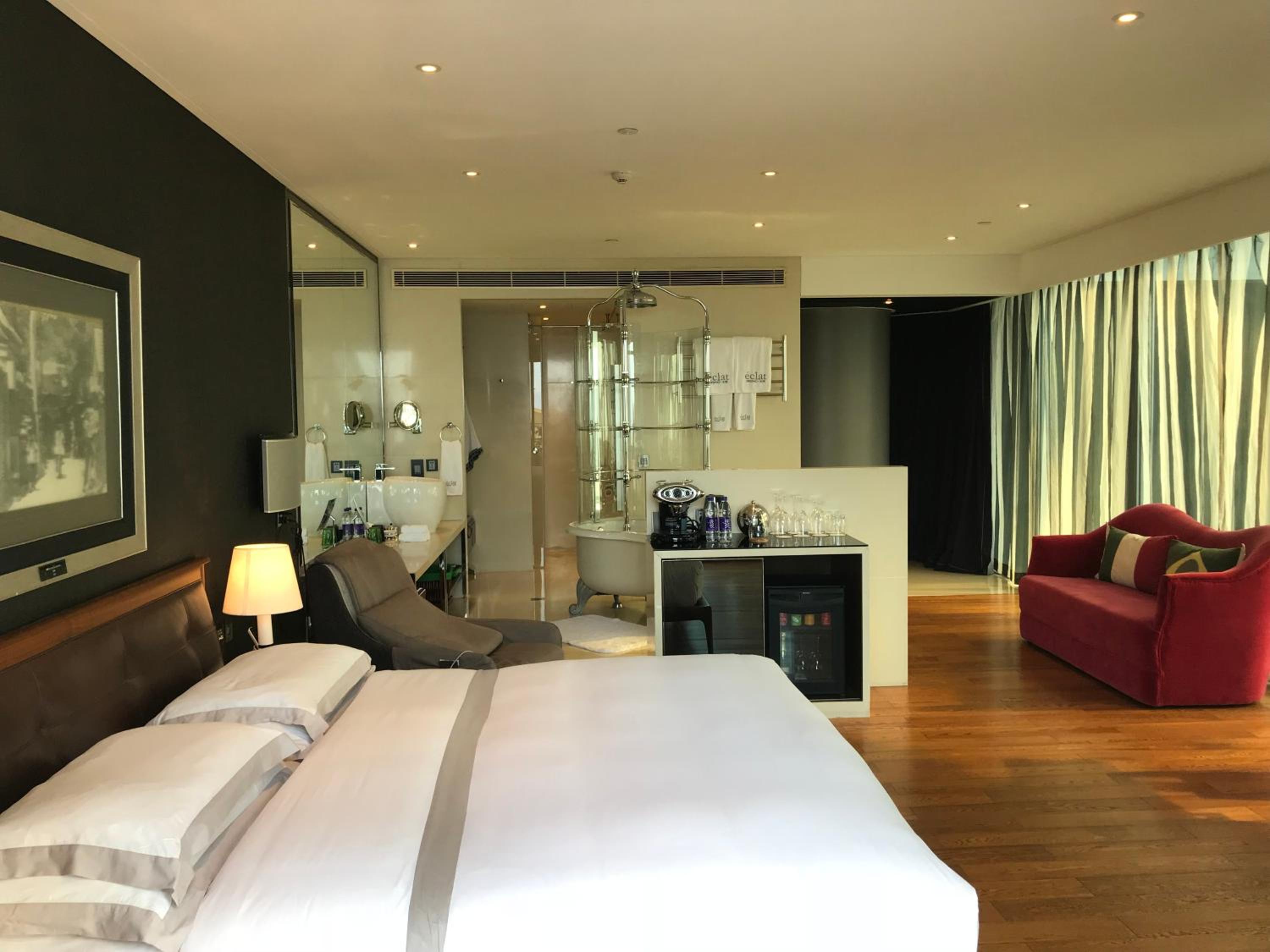 hotel room with a large bed and a red chair