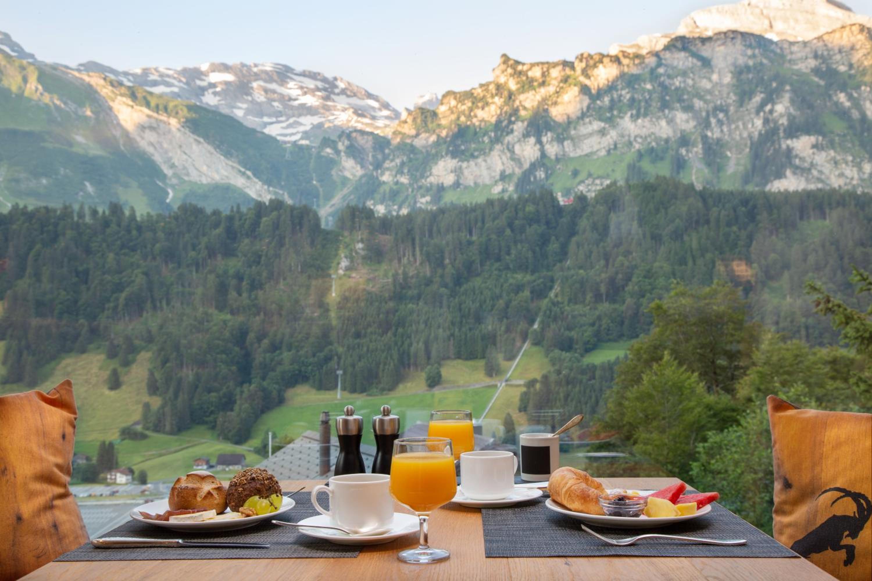 view of the mountains from a table with breakfast on it