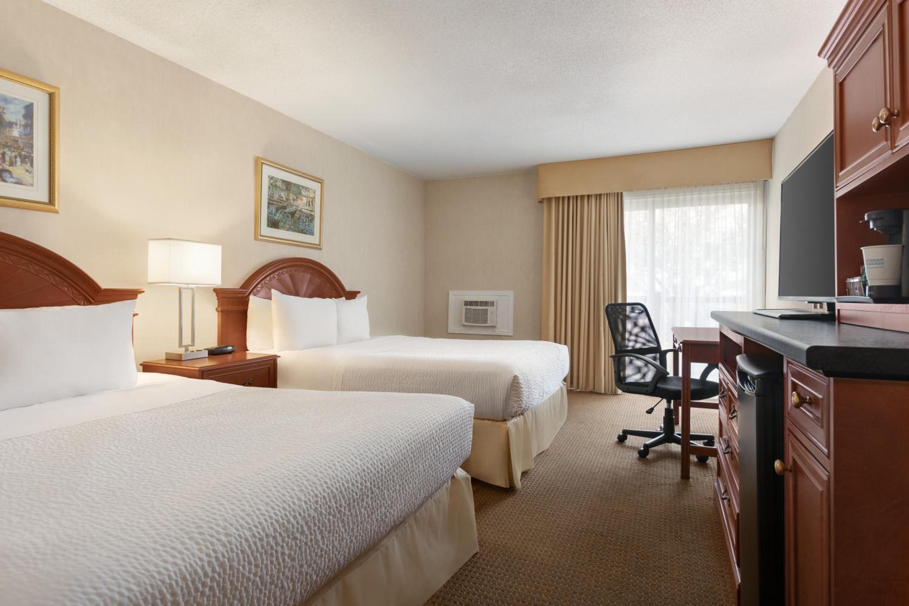 hotel room with two beds and a flat screen tv