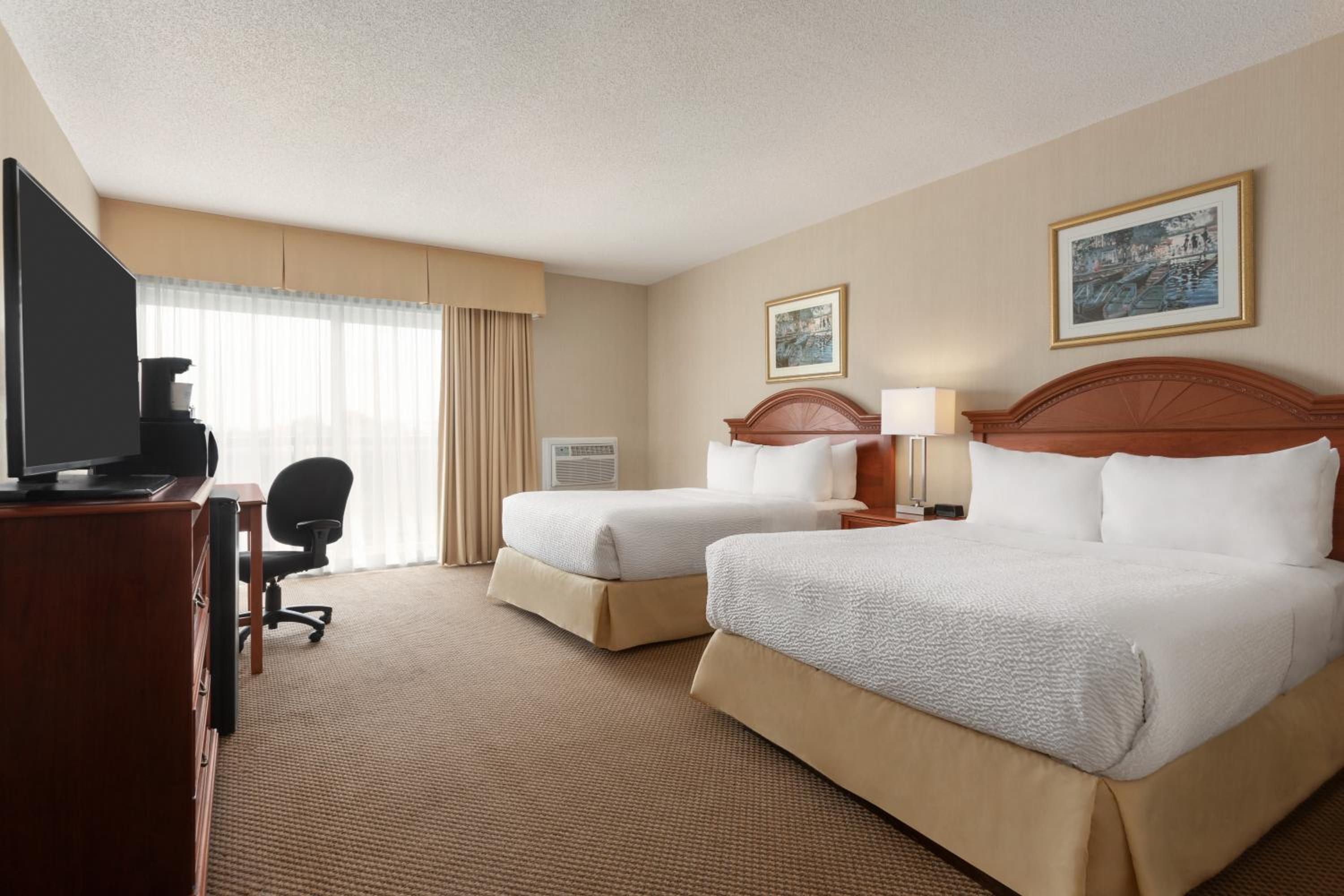 hotel room with two beds and a flat screen tv
