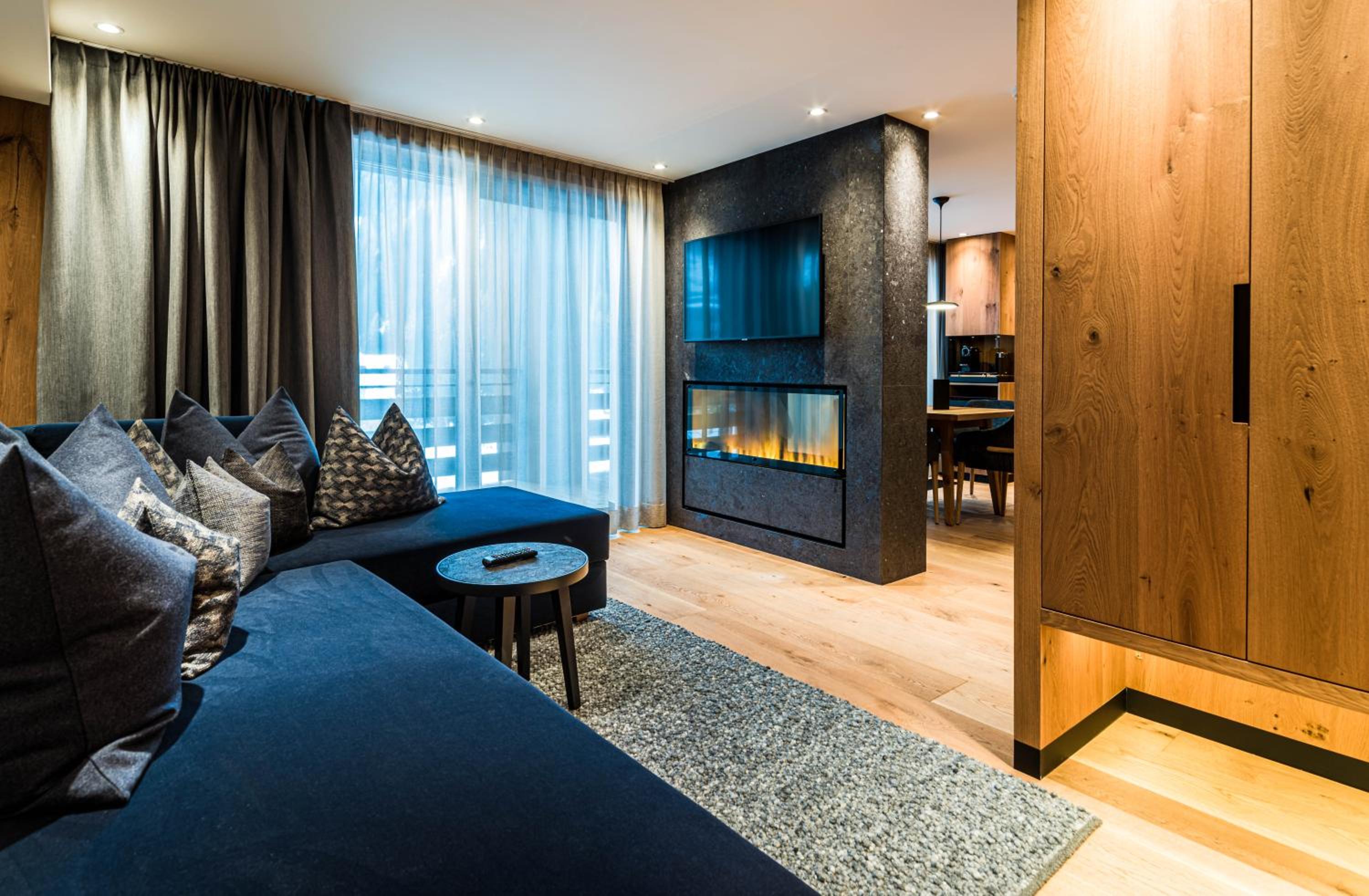 living room with a blue couch and a fire place