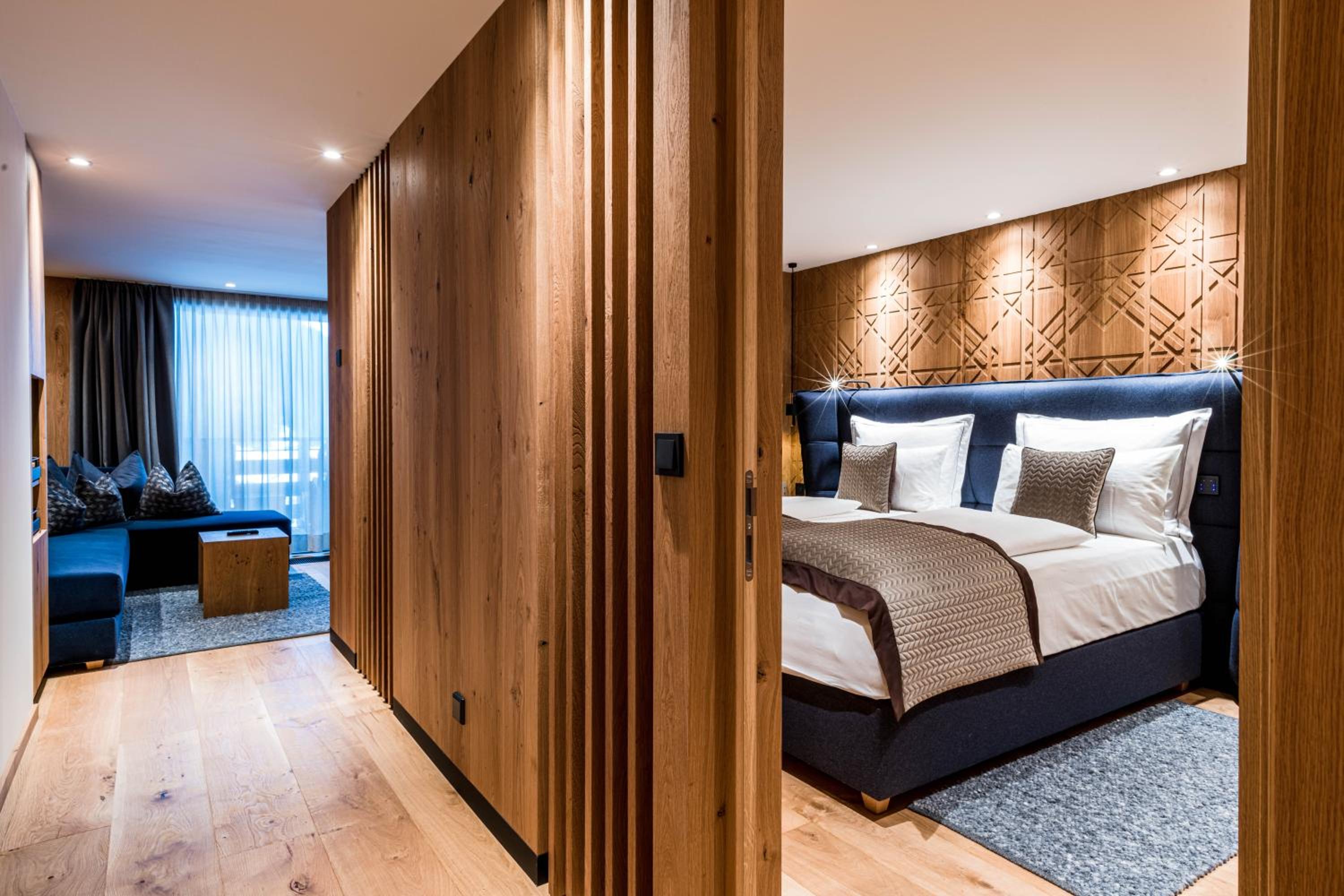 bedroom with wood paneling and a king size bed