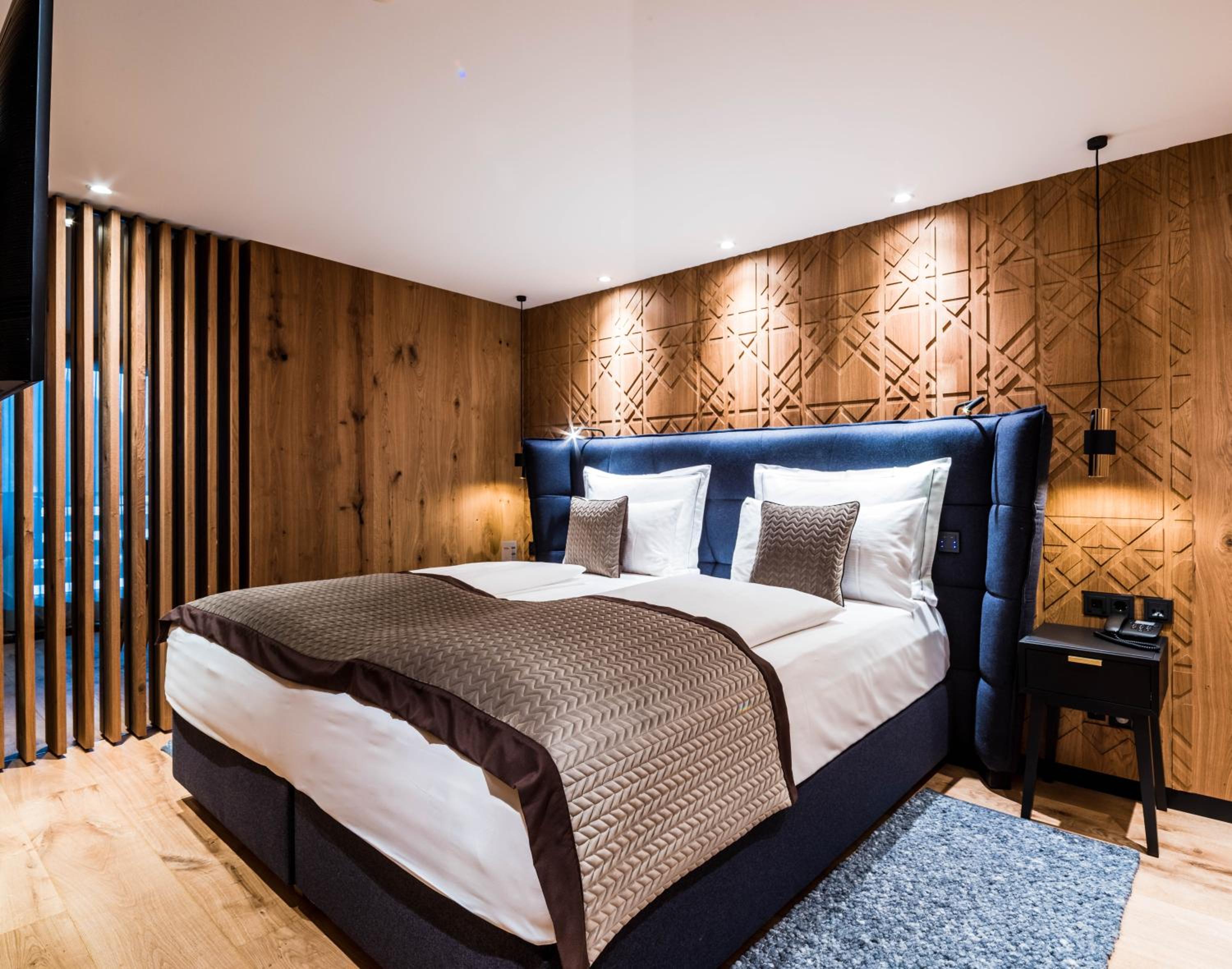 bedroom with wood paneling and a king size bed