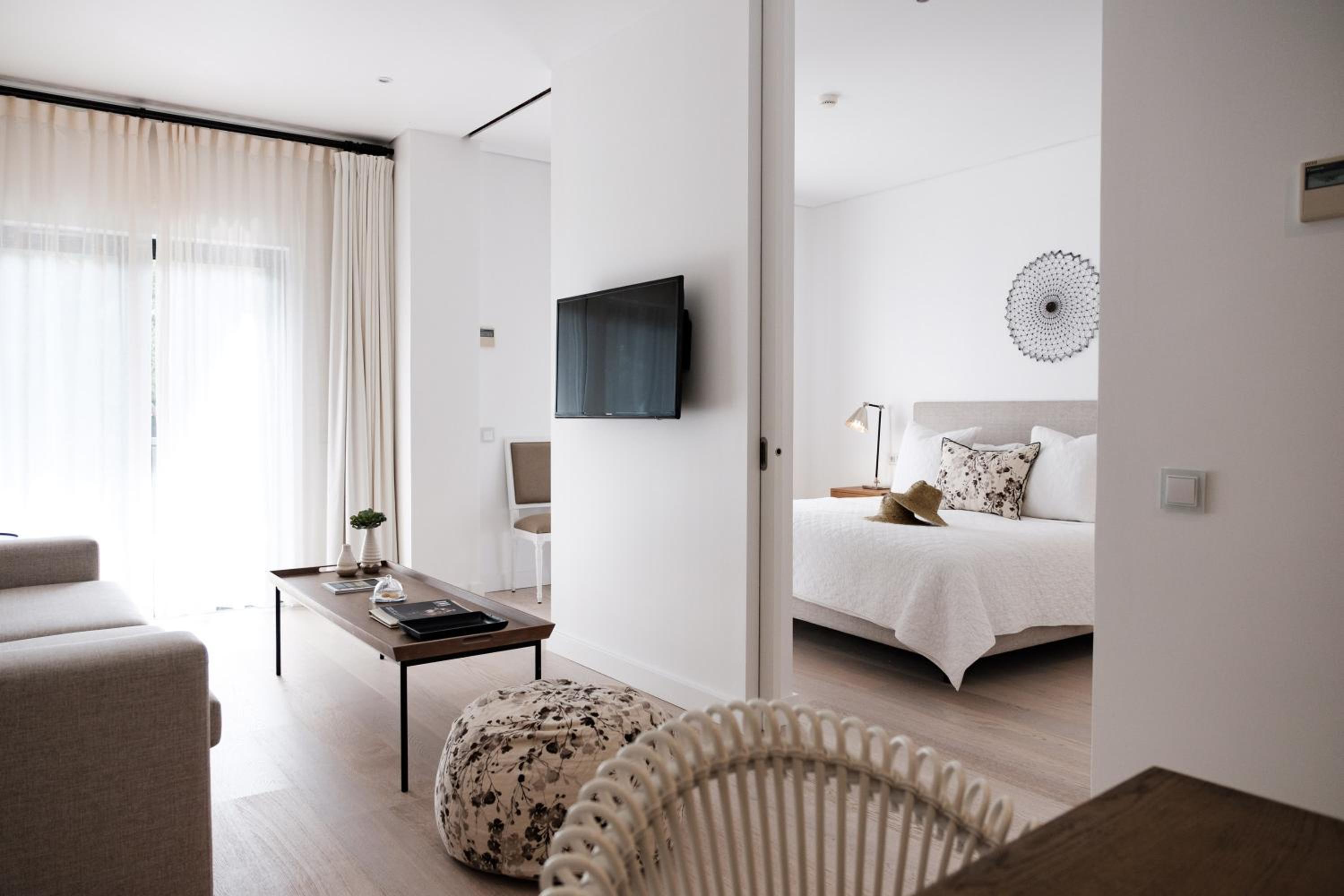 bedroom with a white bed and a flat screen tv