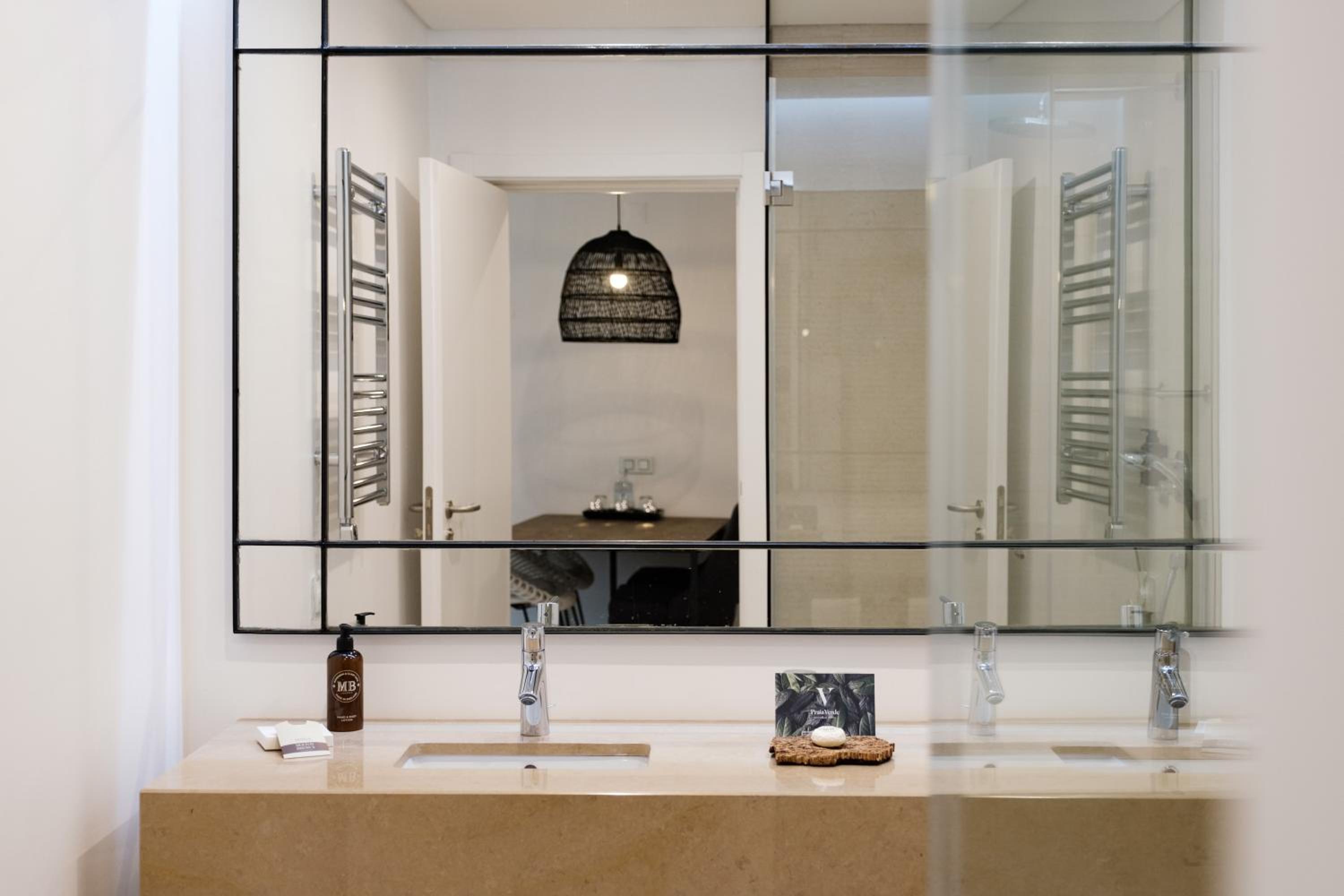 bathroom with two sinks and a large mirror on the wall