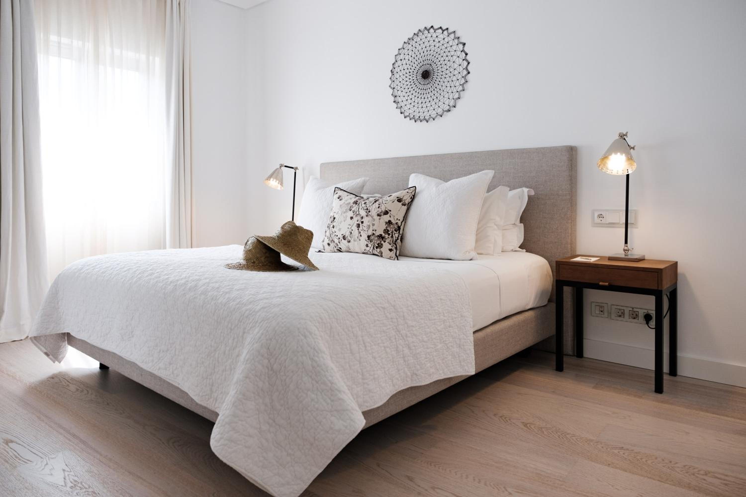 bed with a white comforter and pillows on it