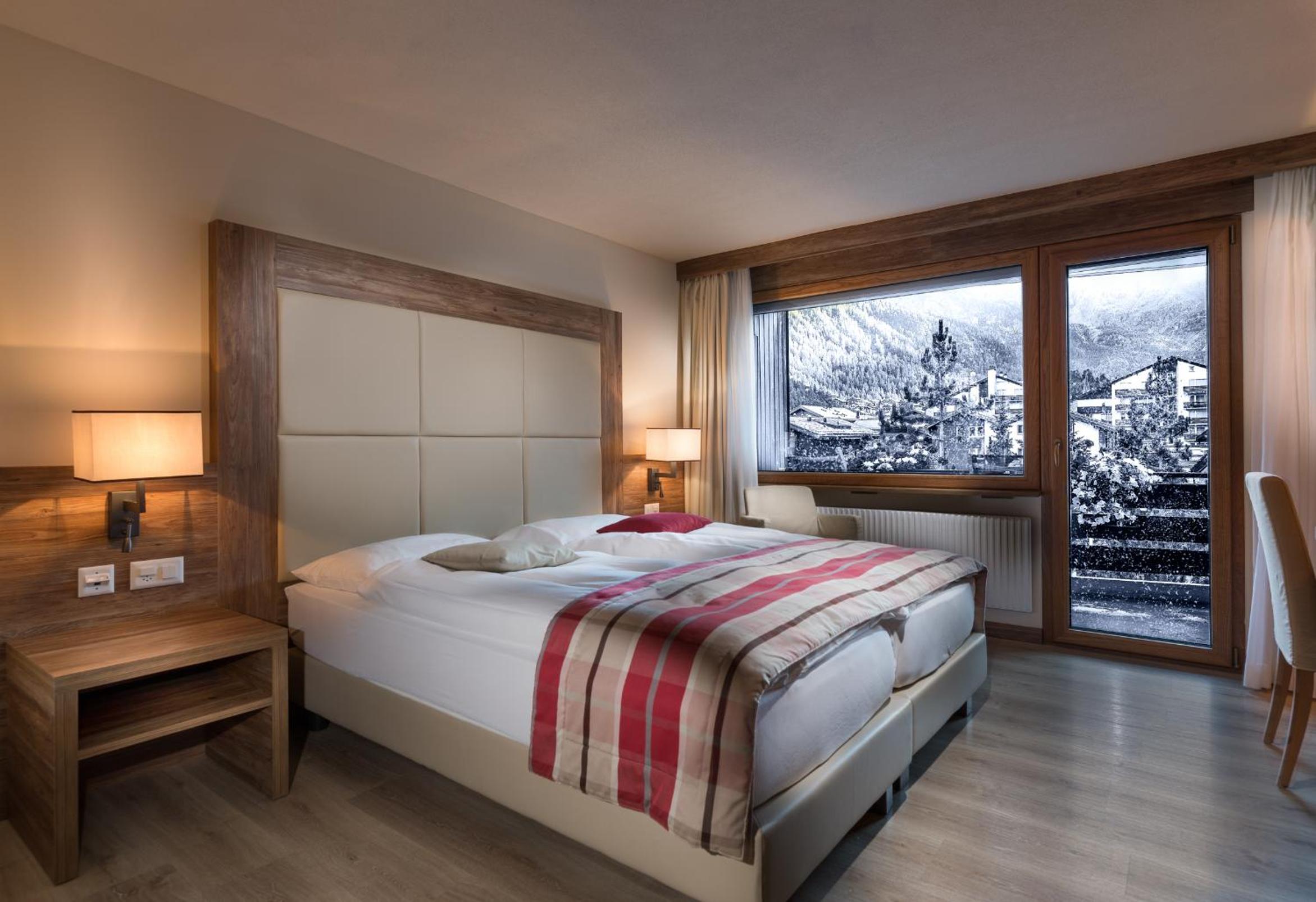hotel room with a view of the snow capped mountains