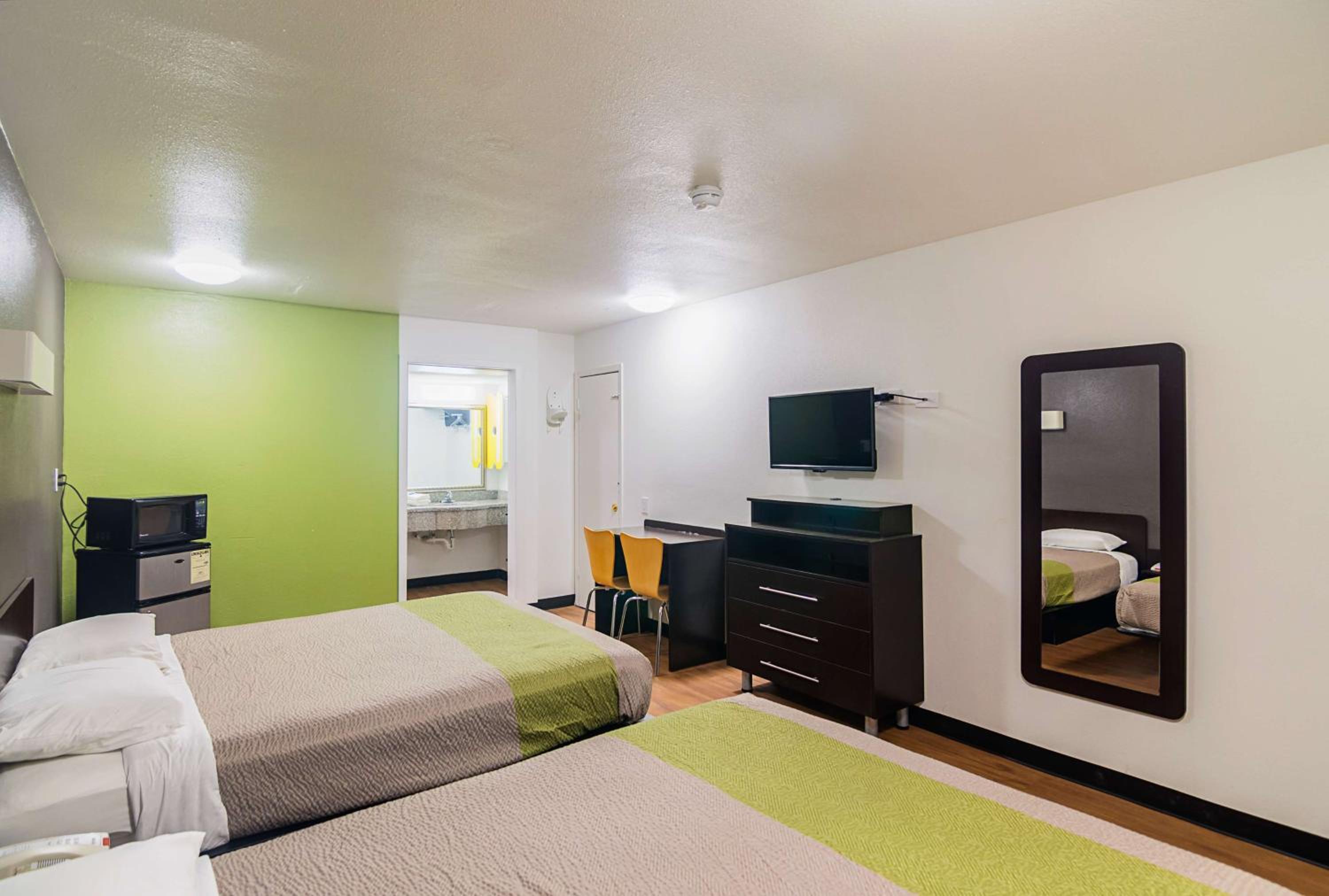 Deluxe Queen Room with Two Queen Beds - Smoking - Photo 1