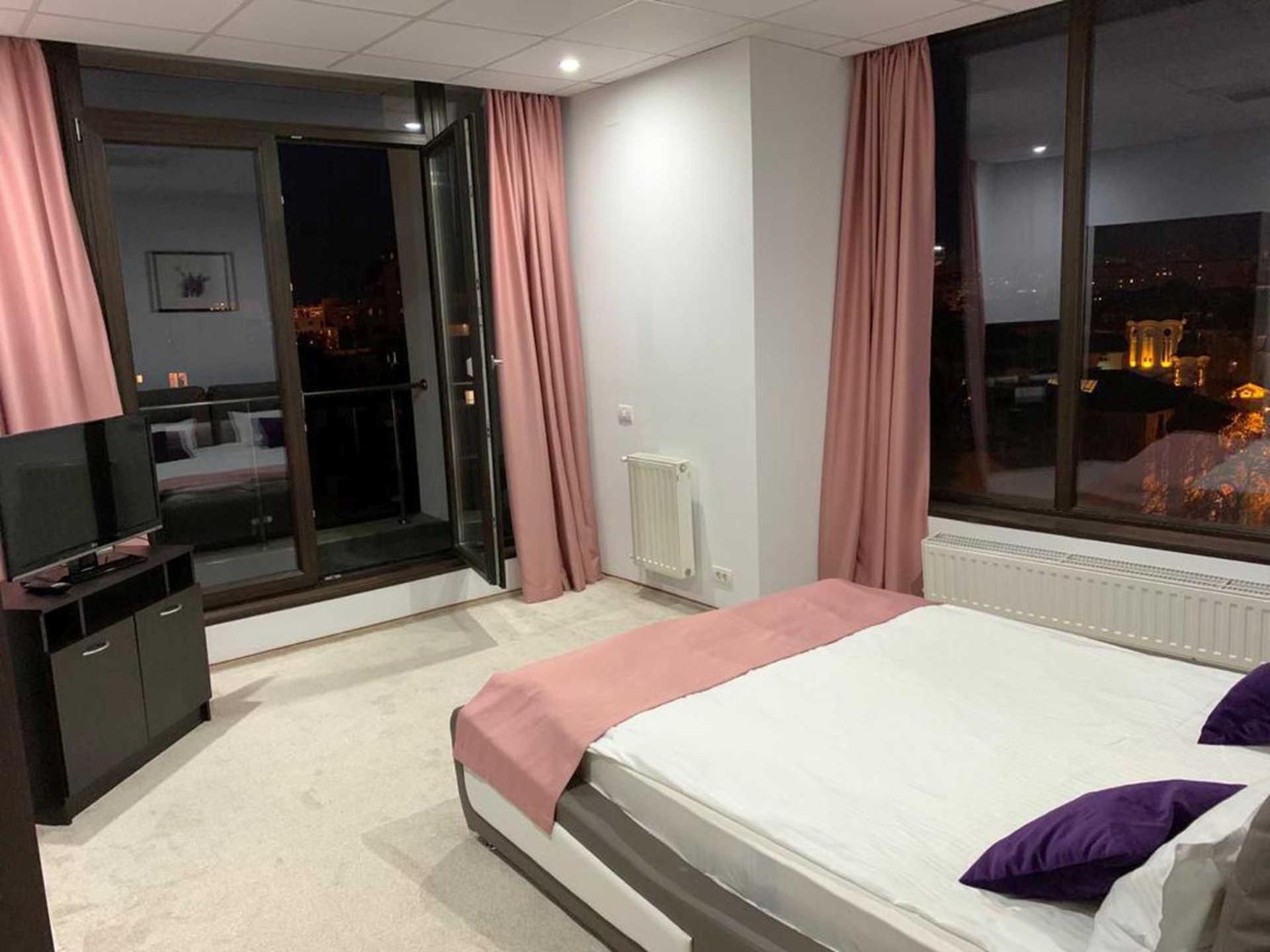 One-Bedroom Apartment with Balcony and City View