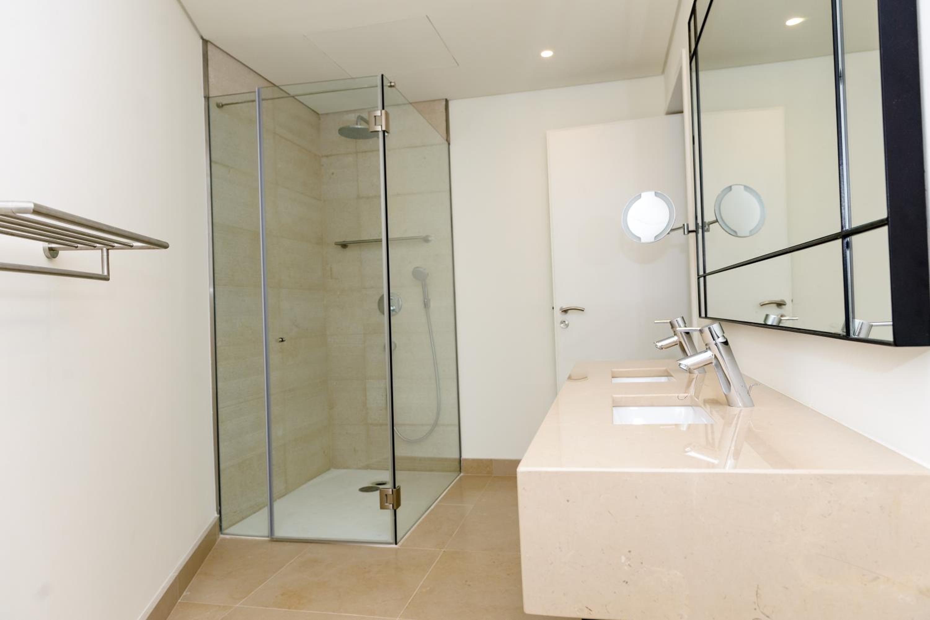 bathroom with two sinks and a walk - in shower
