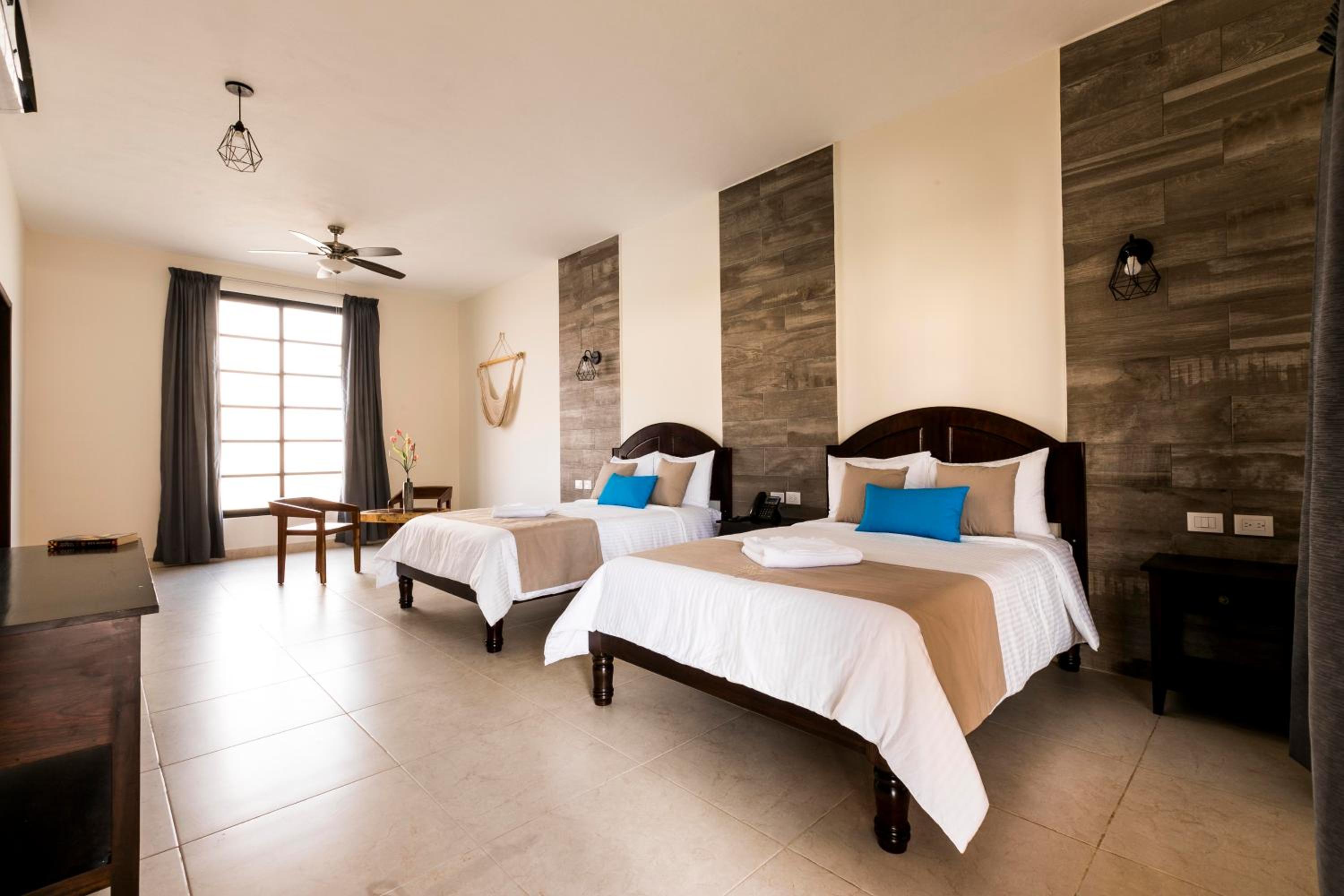 Junior Suite 1 king size bed and 1 double bed, living room, pool and garden view