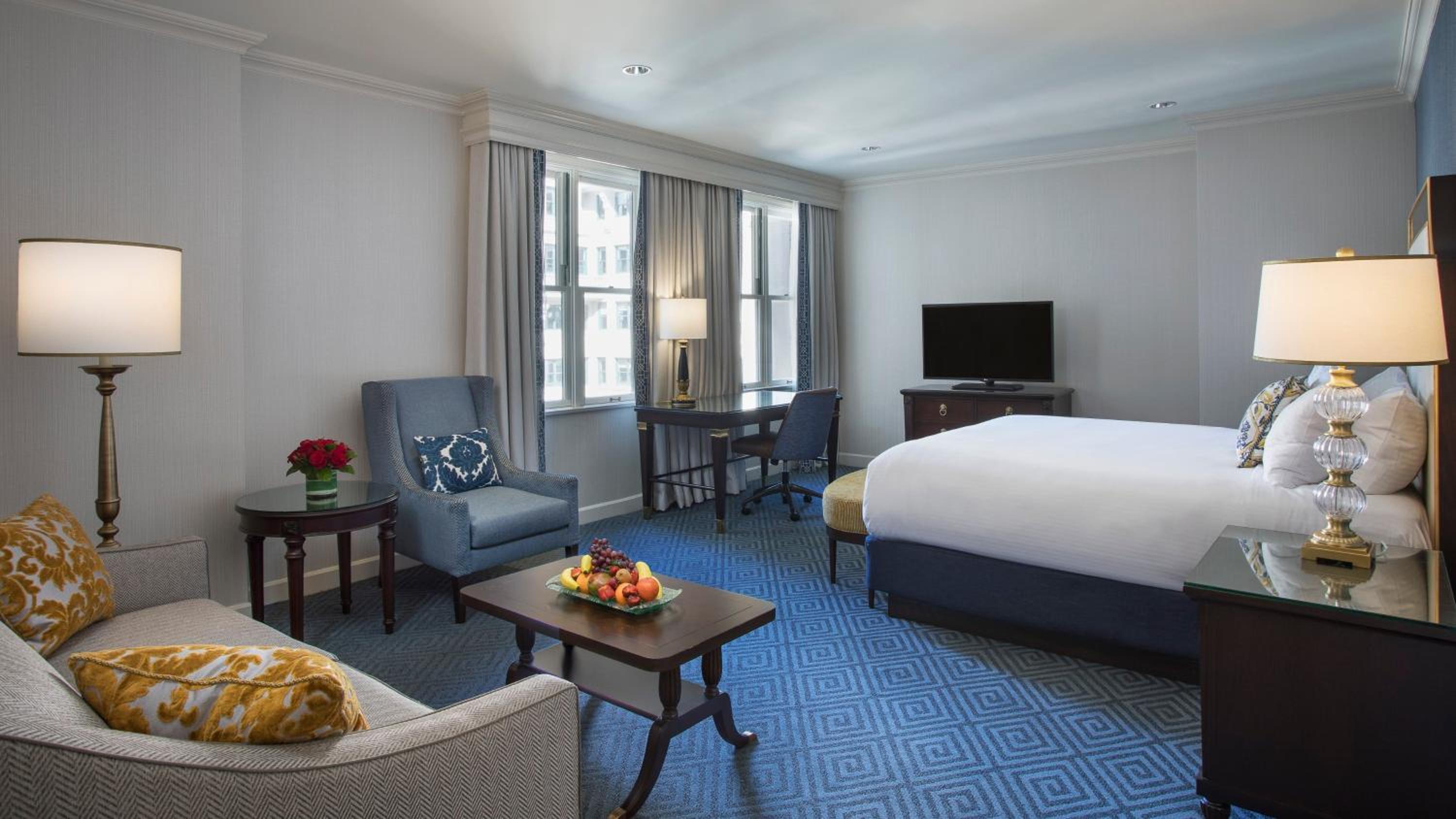hotel room with a king size bed and blue carpet