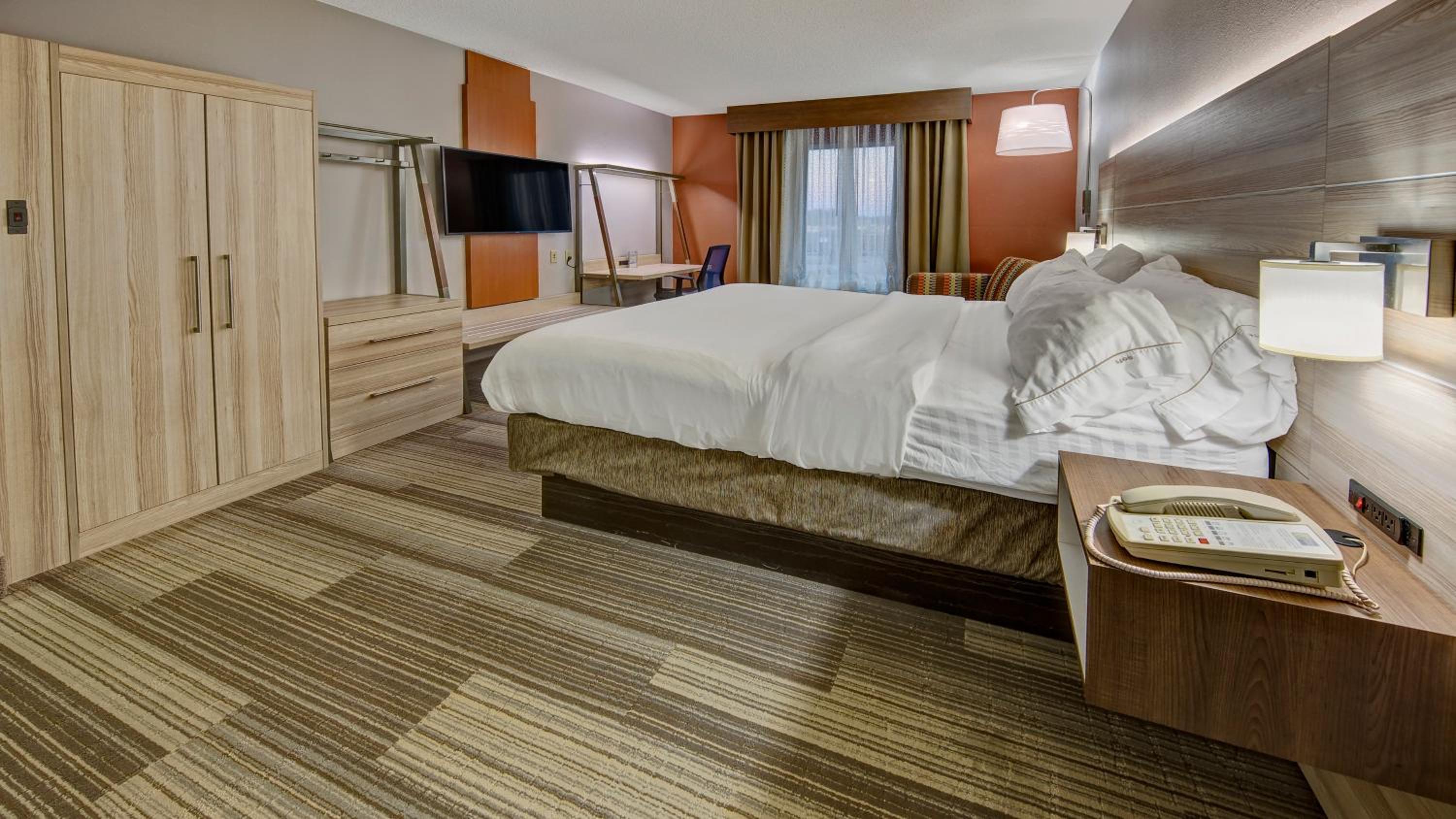 hotel room with a large bed and a flat screen tv