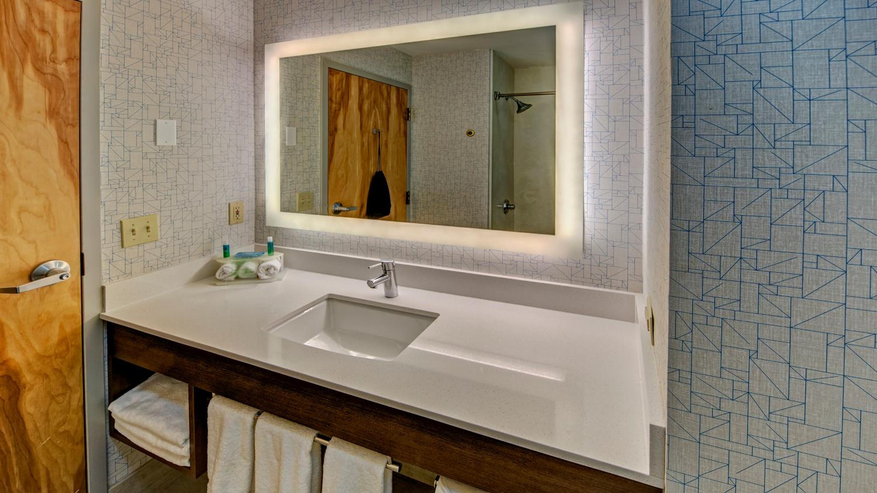 bathroom with a sink, mirror, and towel rack