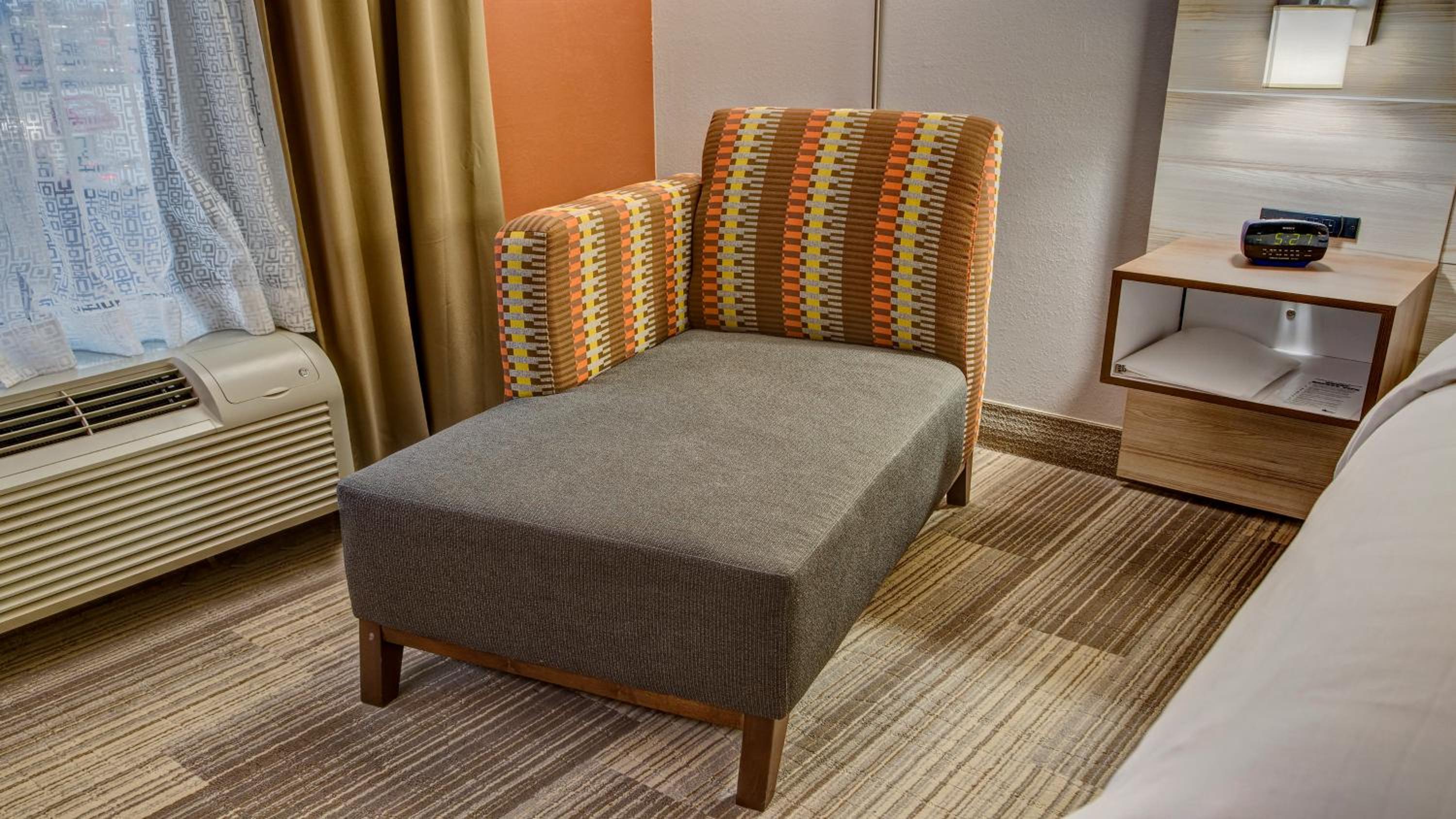 chair with a foot rest in front of a window