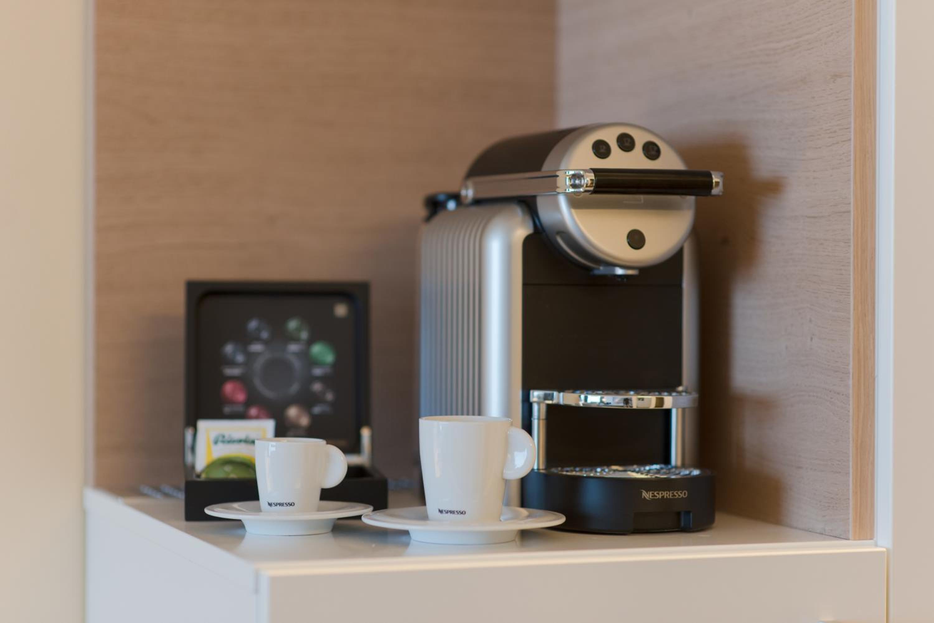 coffee maker and a cup of coffee on a shelf