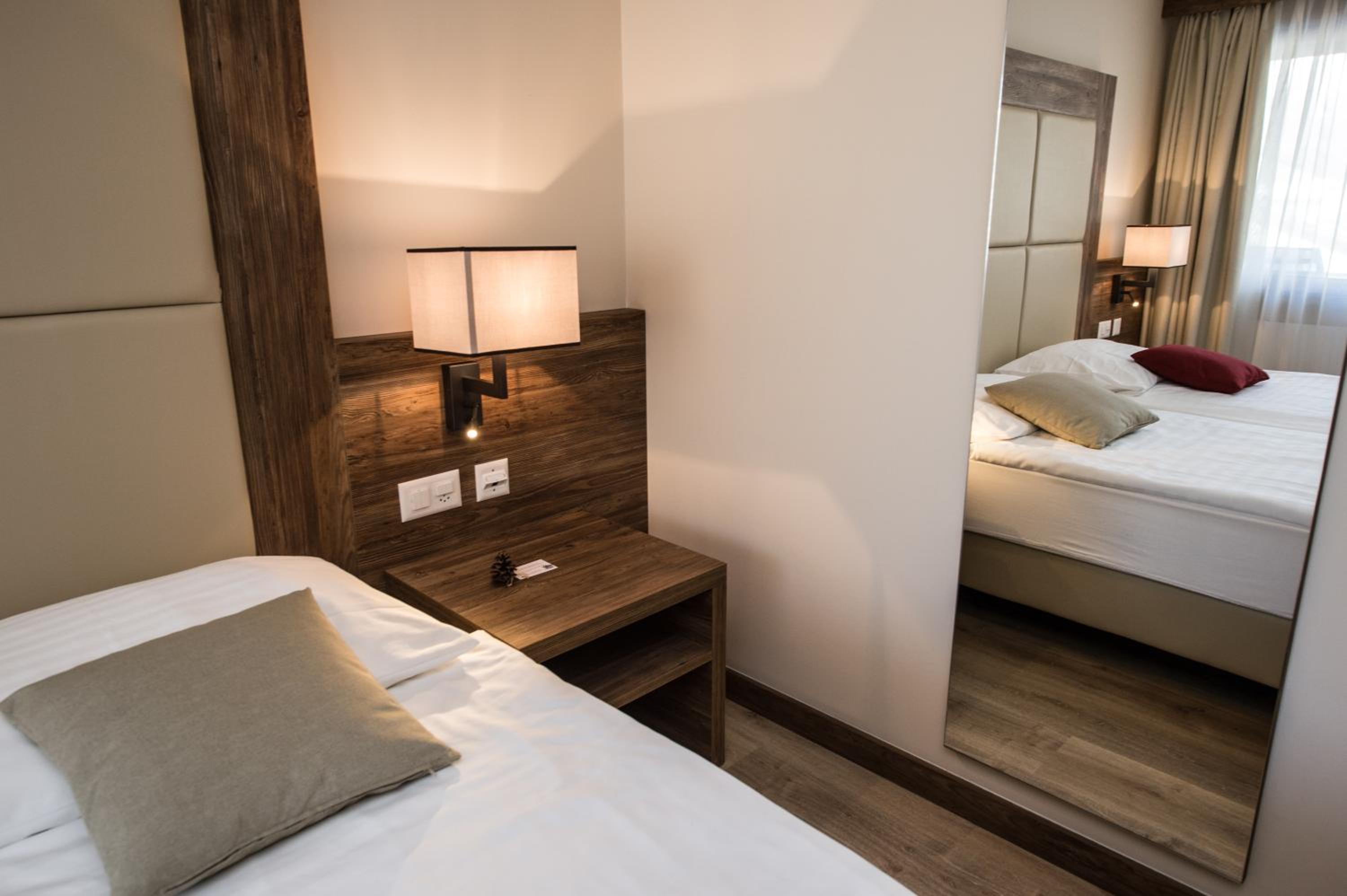 bedroom with a white bed and a wooden headboard