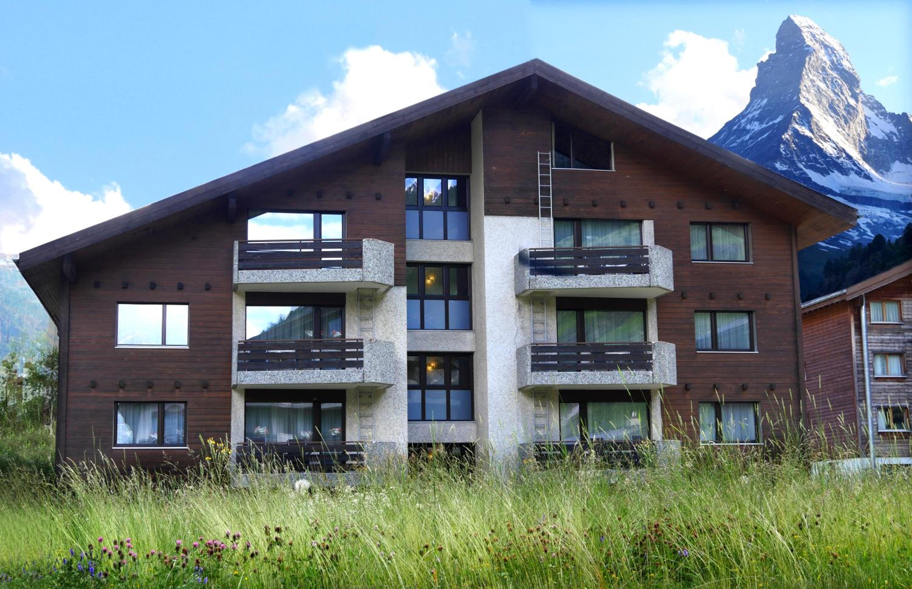 view of a building with a mountain in the background