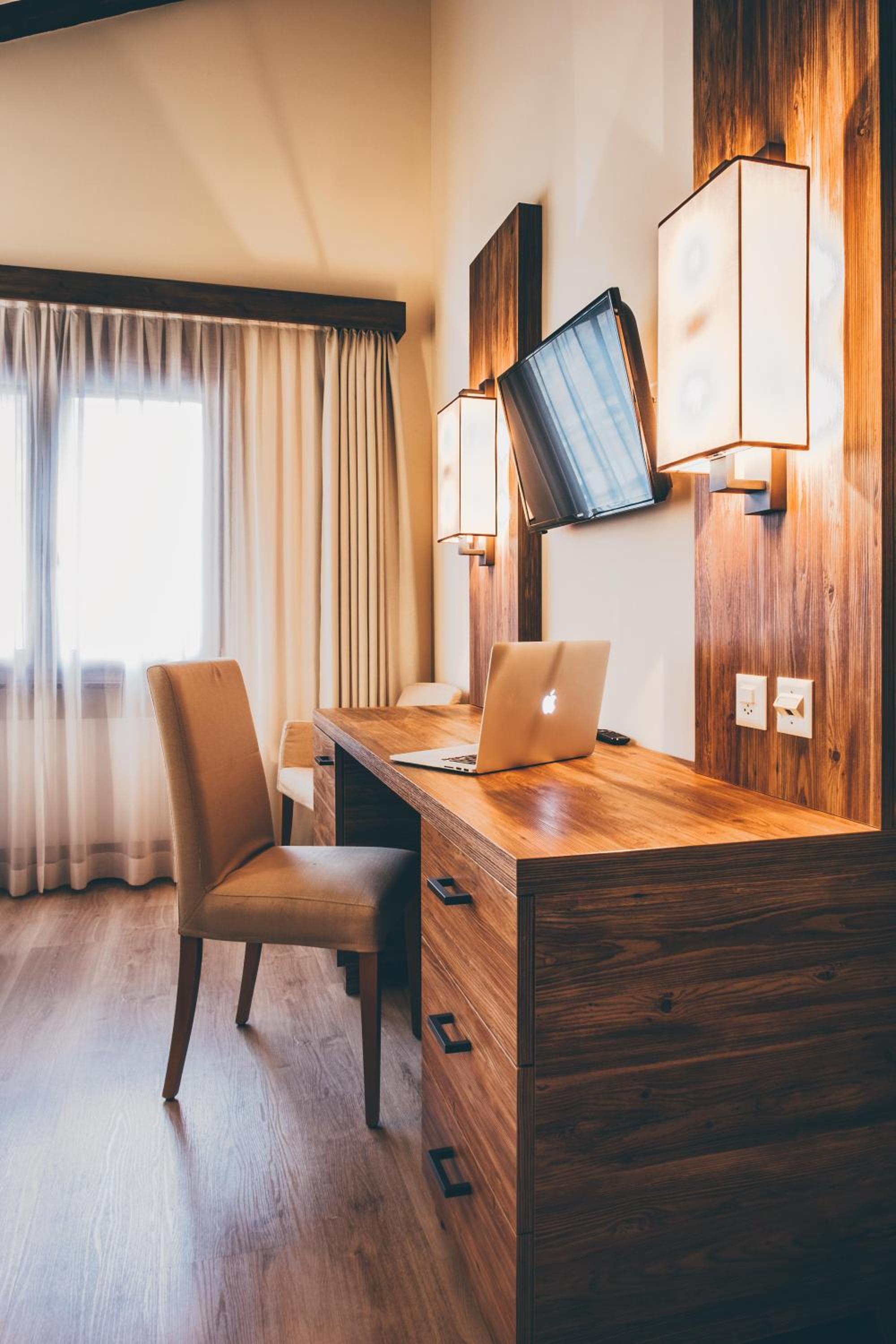 desk with a laptop and a chair in front of it