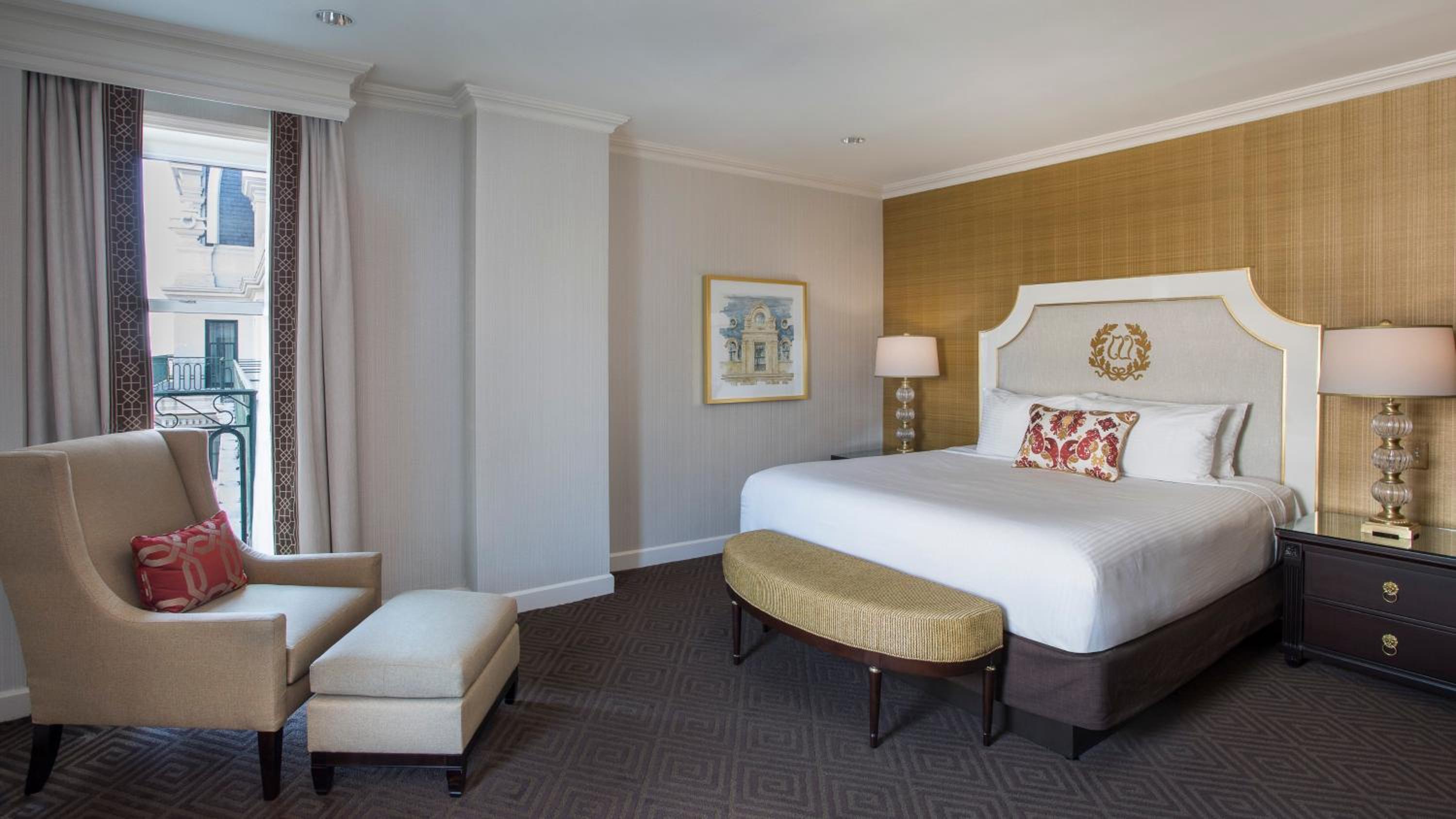 hotel room with a king size bed and two chairs