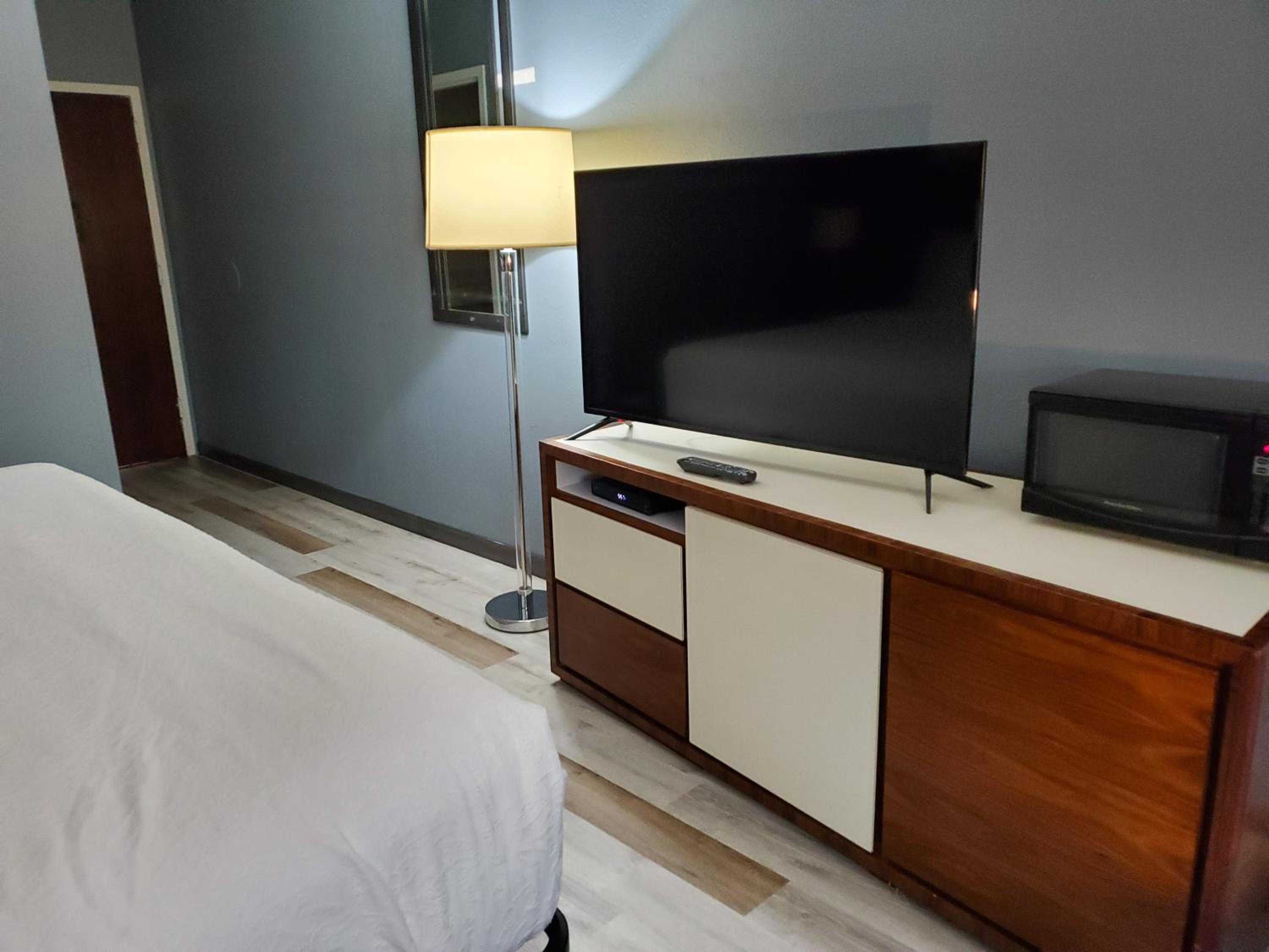 hotel room with a flat screen tv on the dresser