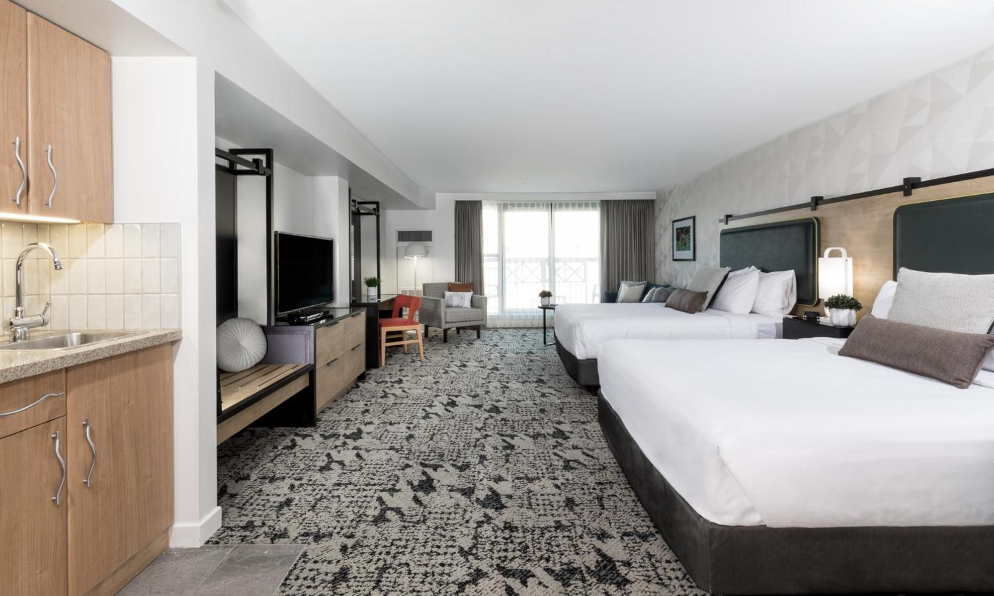 Deluxe Queen Room with Two Queen Beds and Sofa Bed - Photo 1
