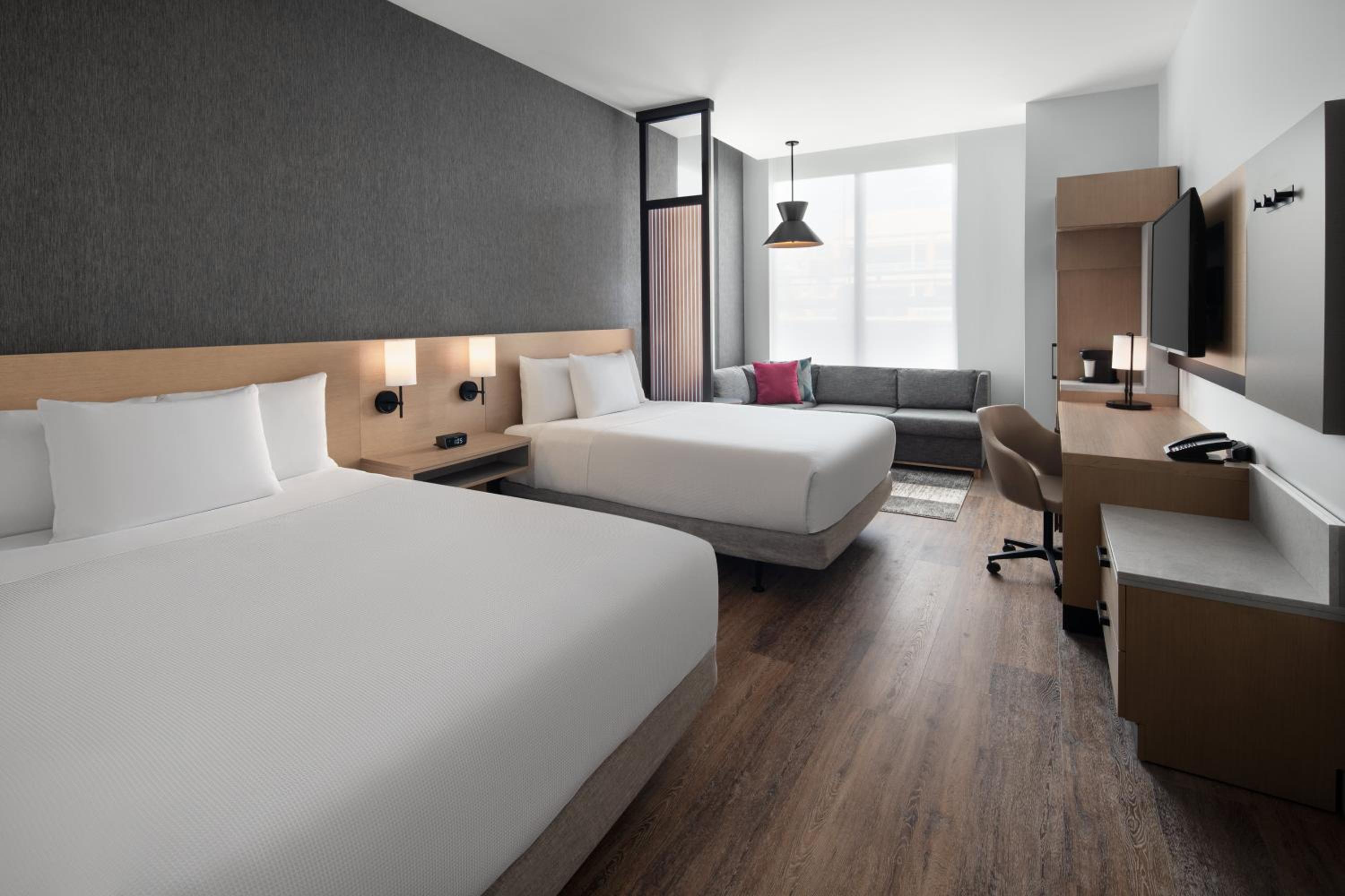 Queen Room with Two Queen Beds with Sofa Bed and Tub - Disability Access - Photo 1