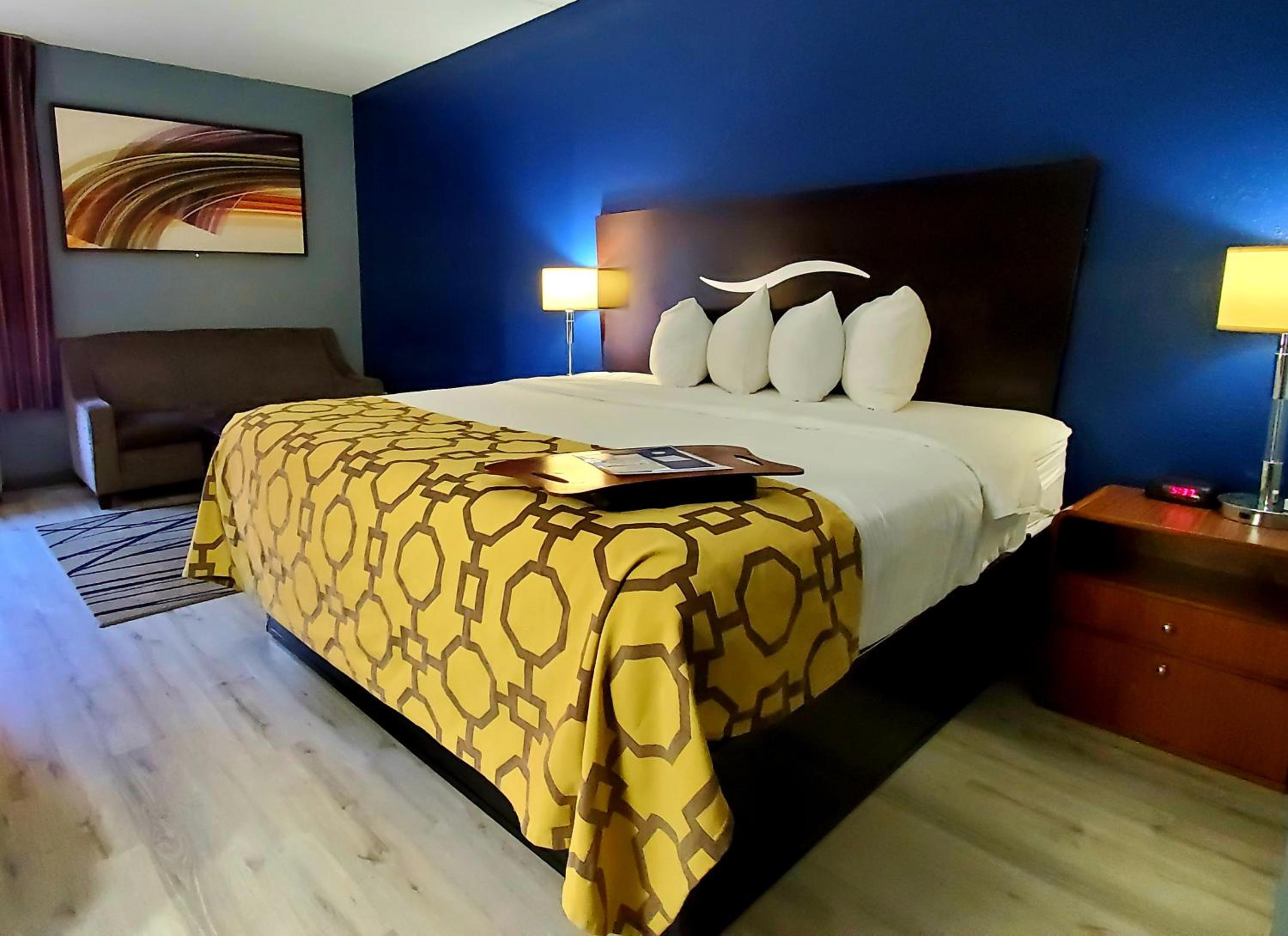 hotel room with a king size bed and blue walls