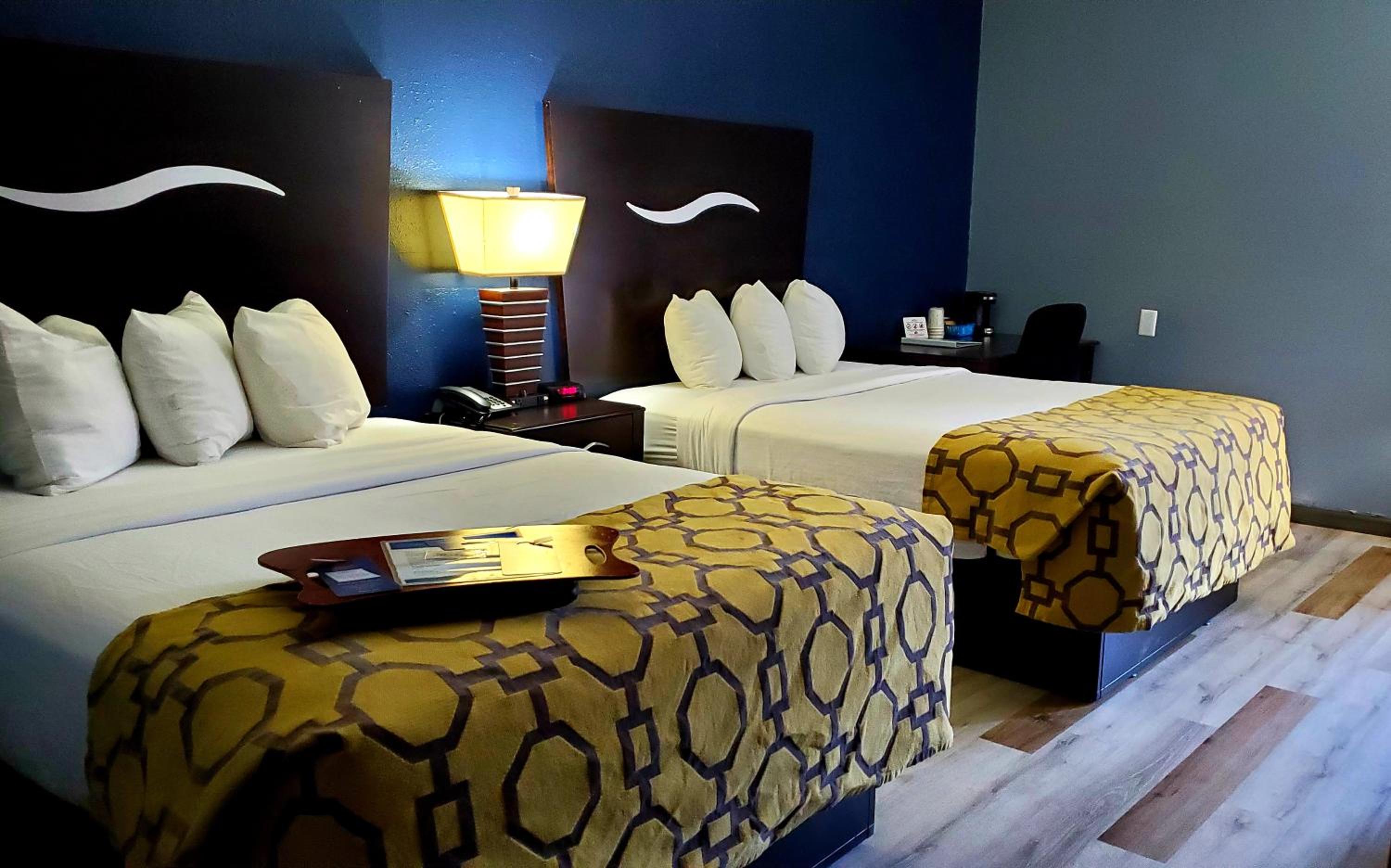 hotel room with two beds and a tray on the bed