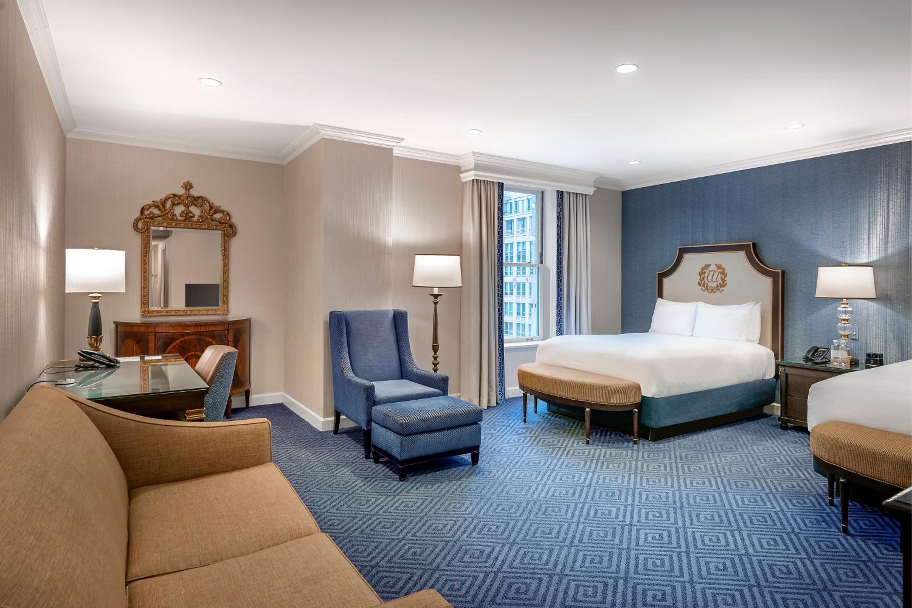 hotel room with a king size bed and a sofa