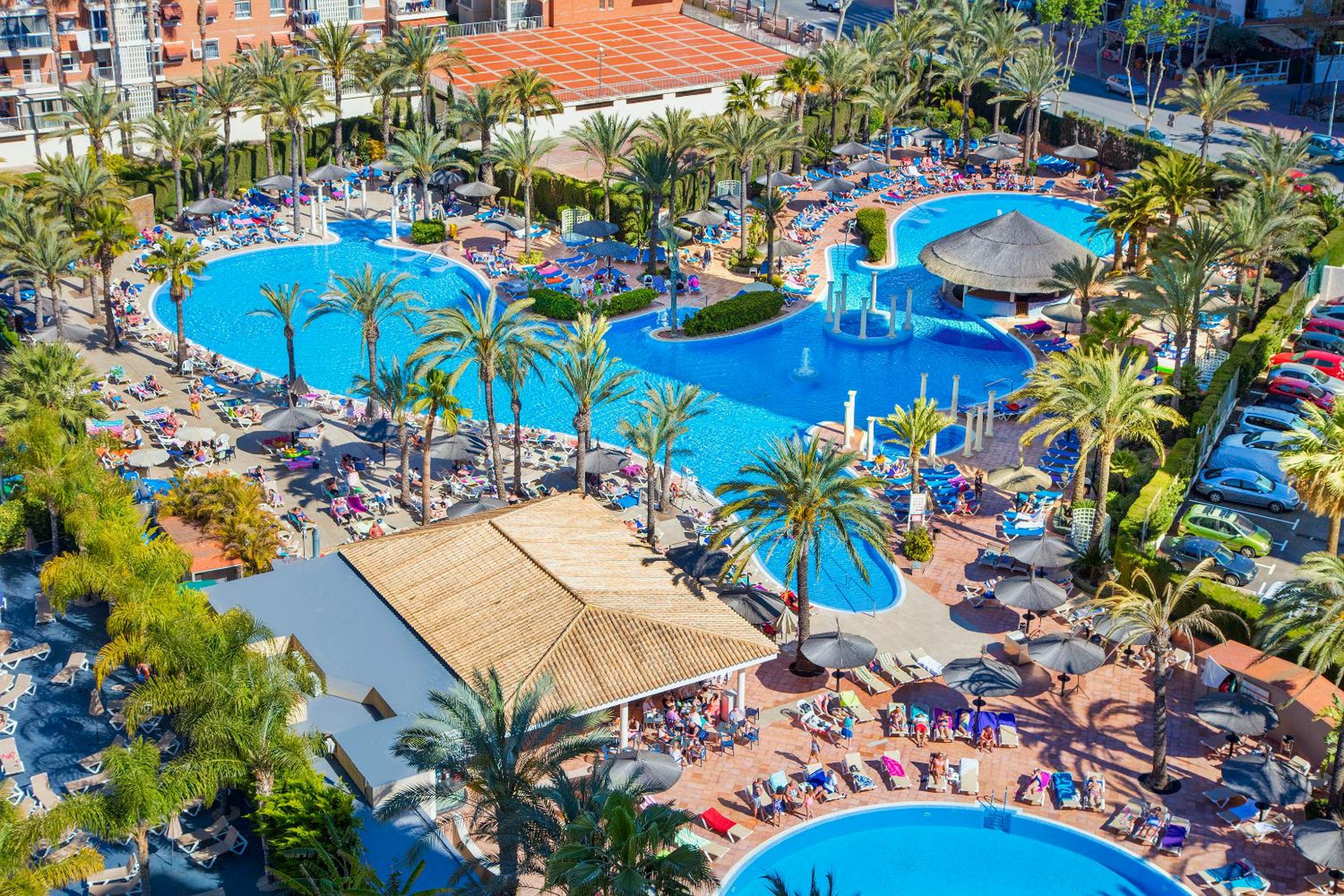 Relax by the stunning pools and lush palms!