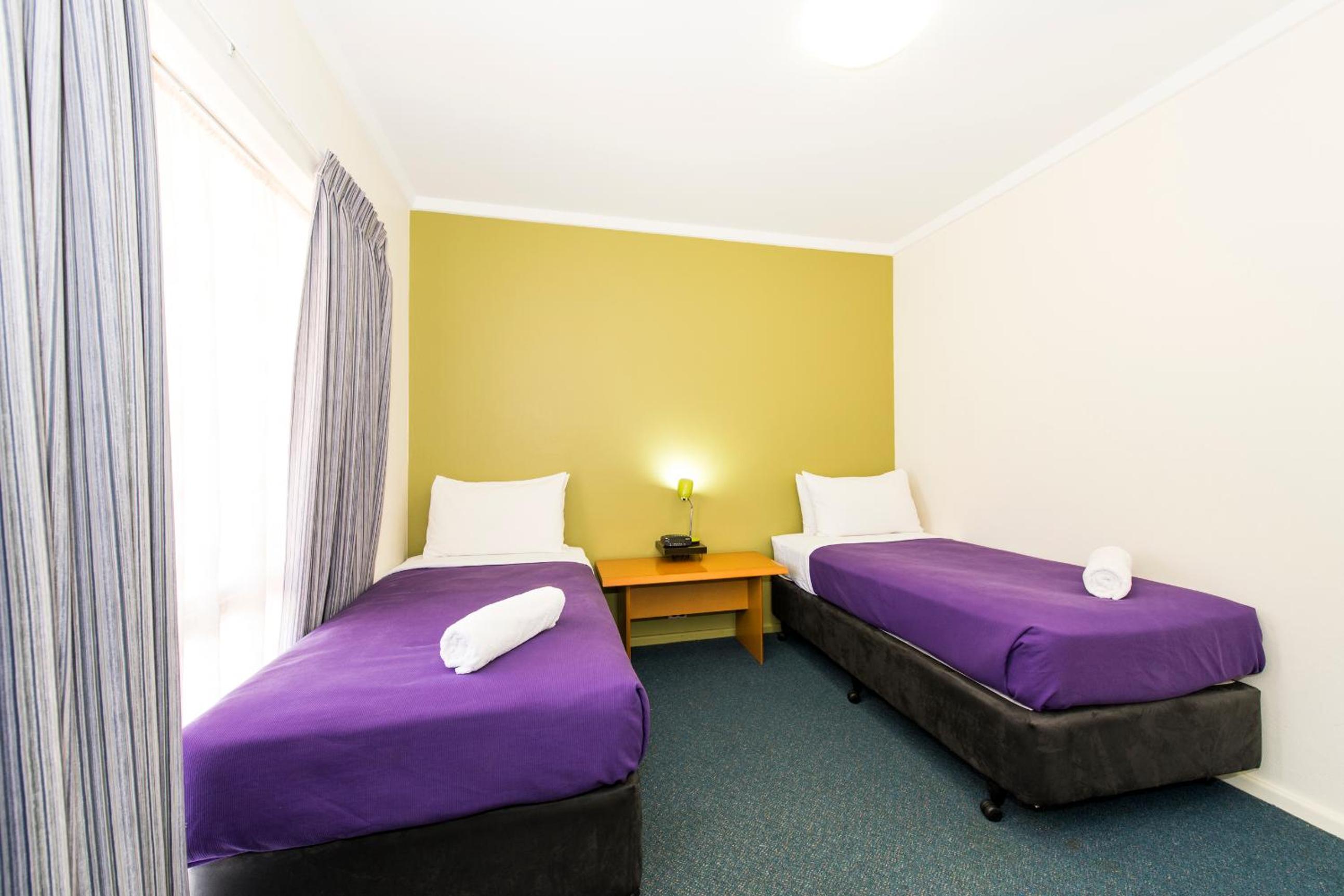 Standard Room with One Queen Bed and Two Single Beds - Photo 1