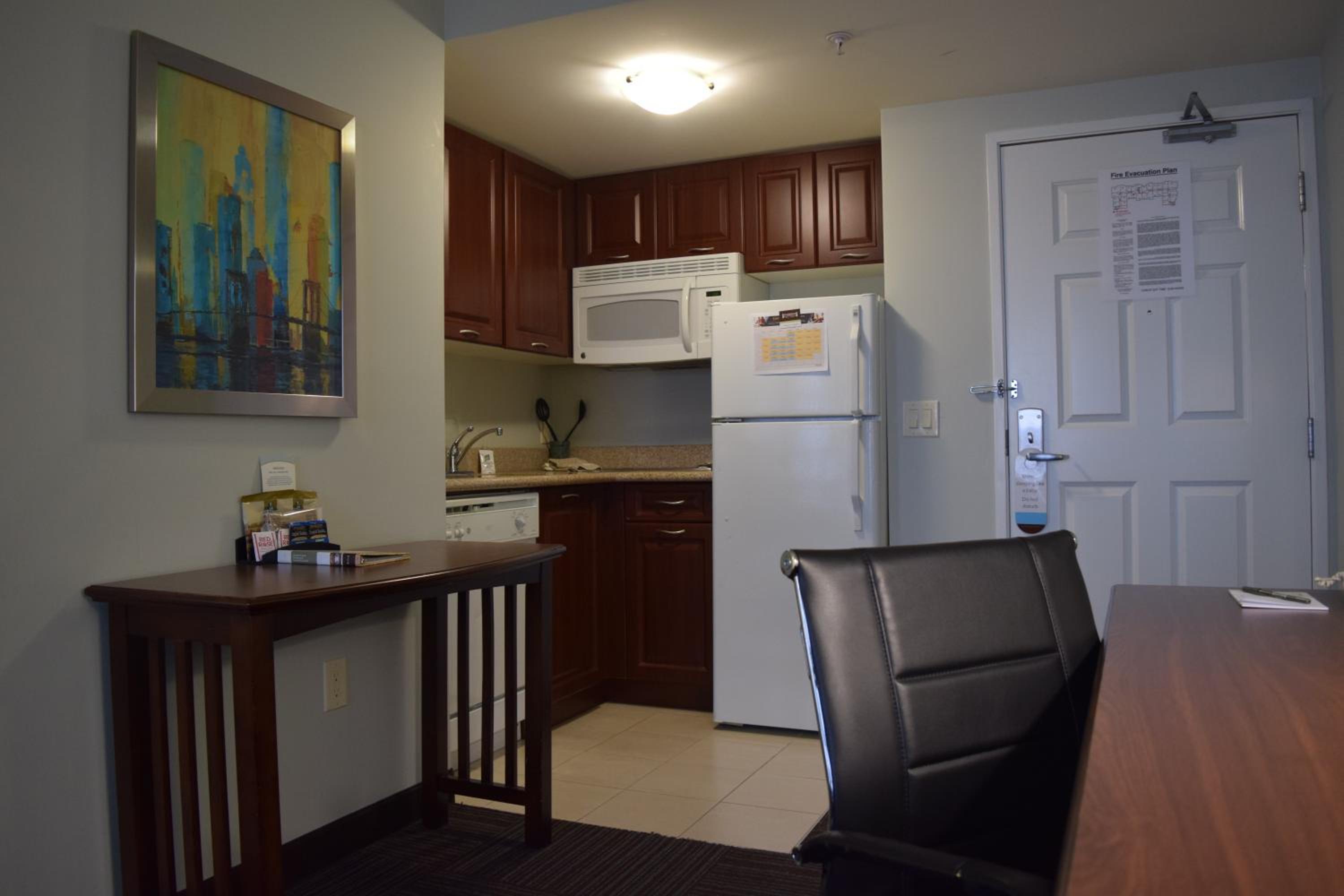 small kitchen with a table and chairs in front of it