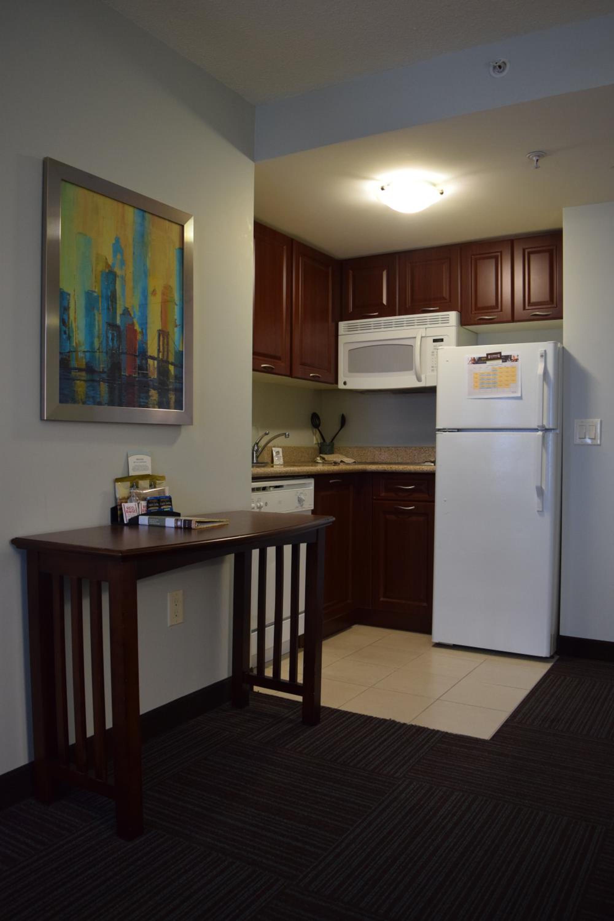 kitchen with a small table in front of the refrigerator