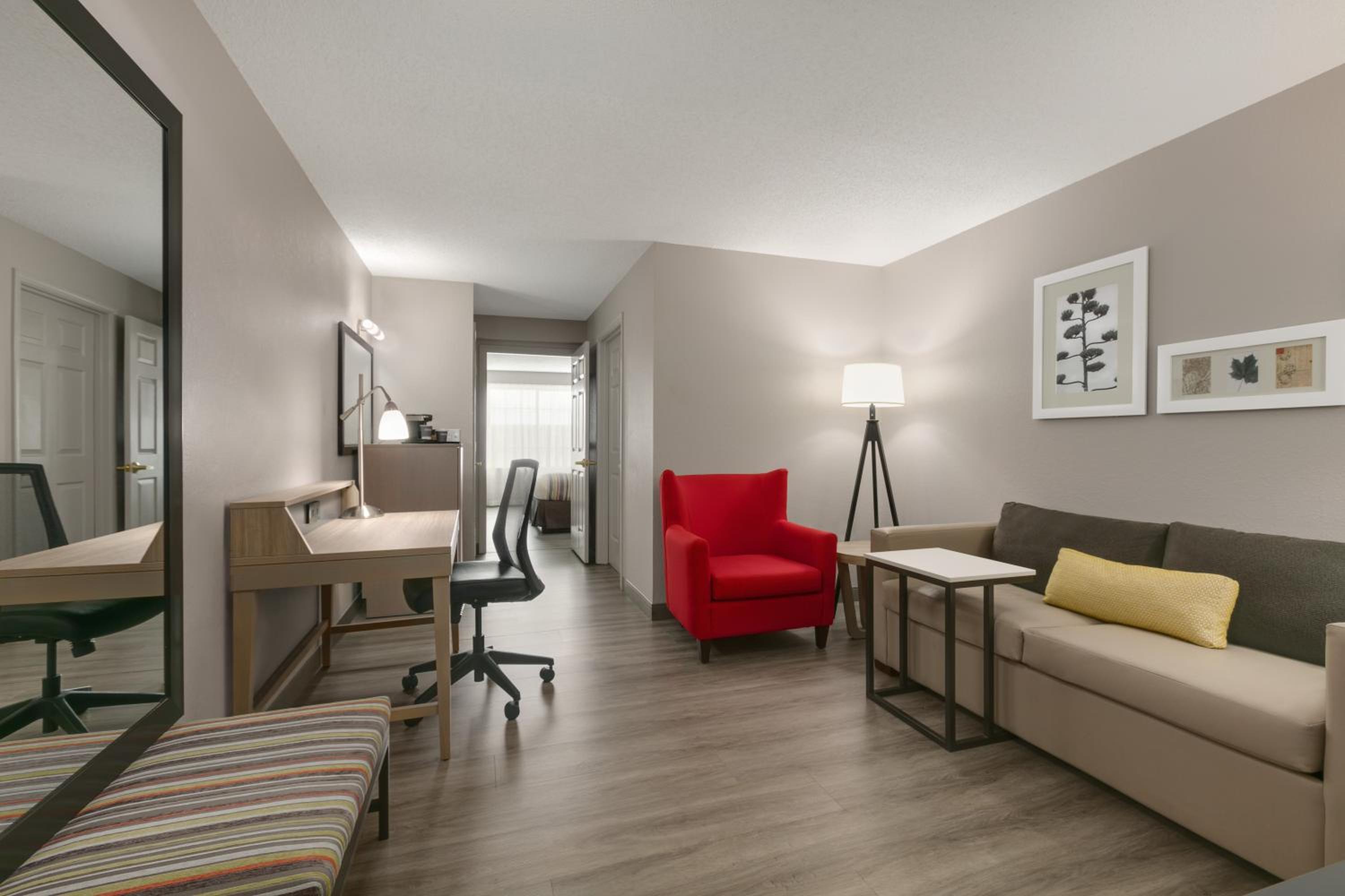 living room with a couch, desk, and chair