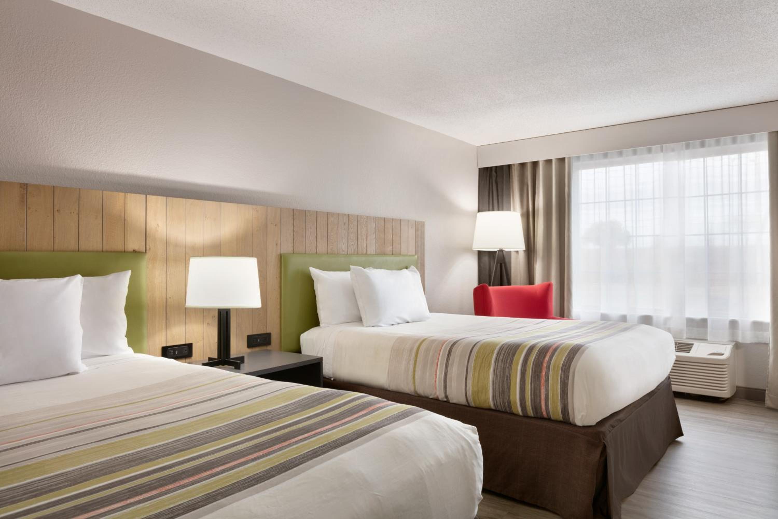 hotel room with two beds and a flat screen tv