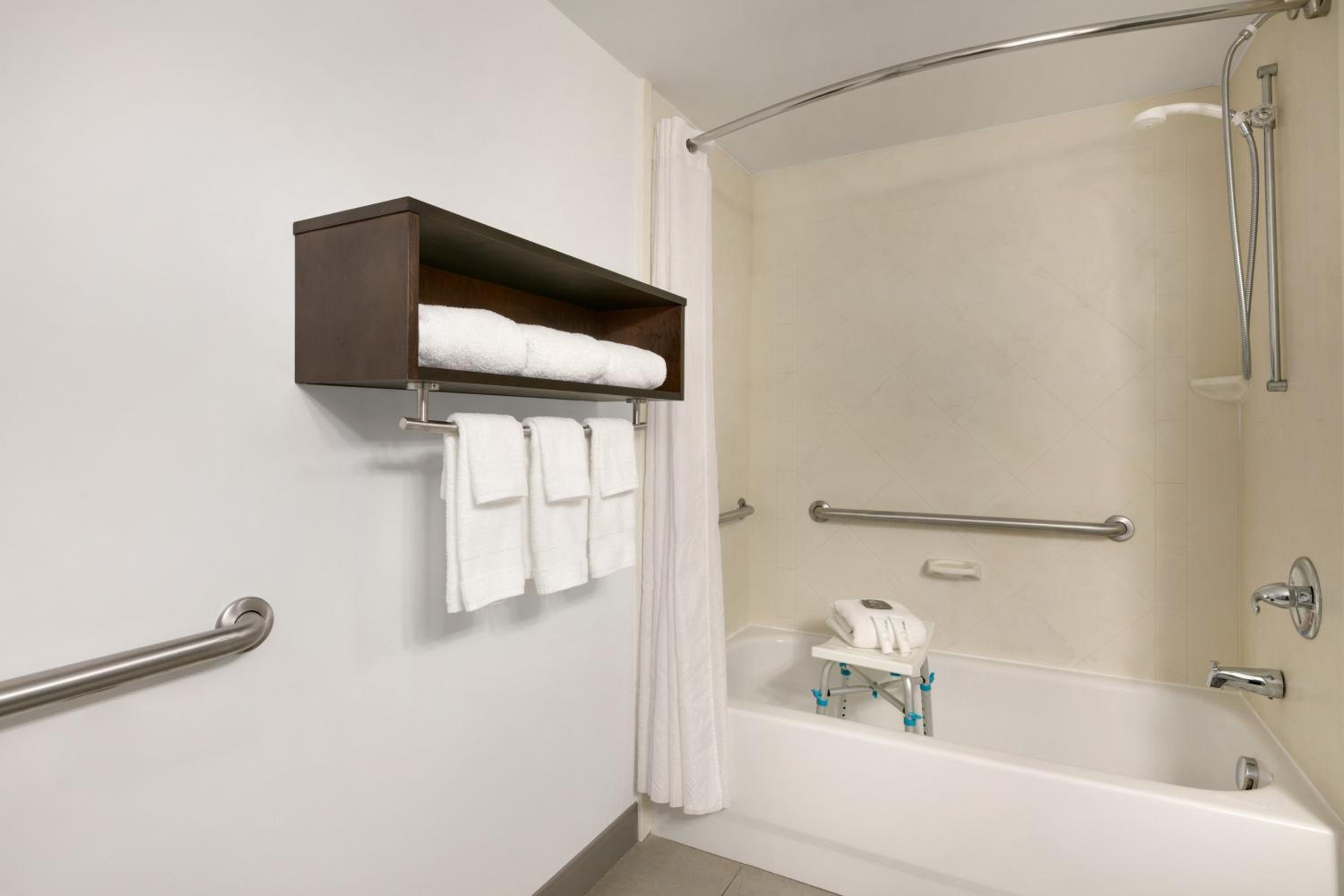 bathroom with a shower, toilet, and bathtub