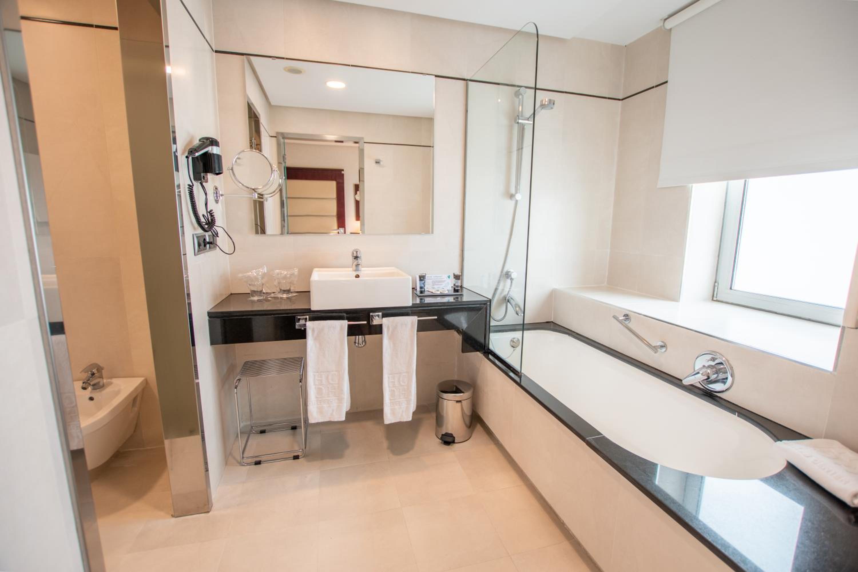 Experience luxury in this modern, inviting bathroom.