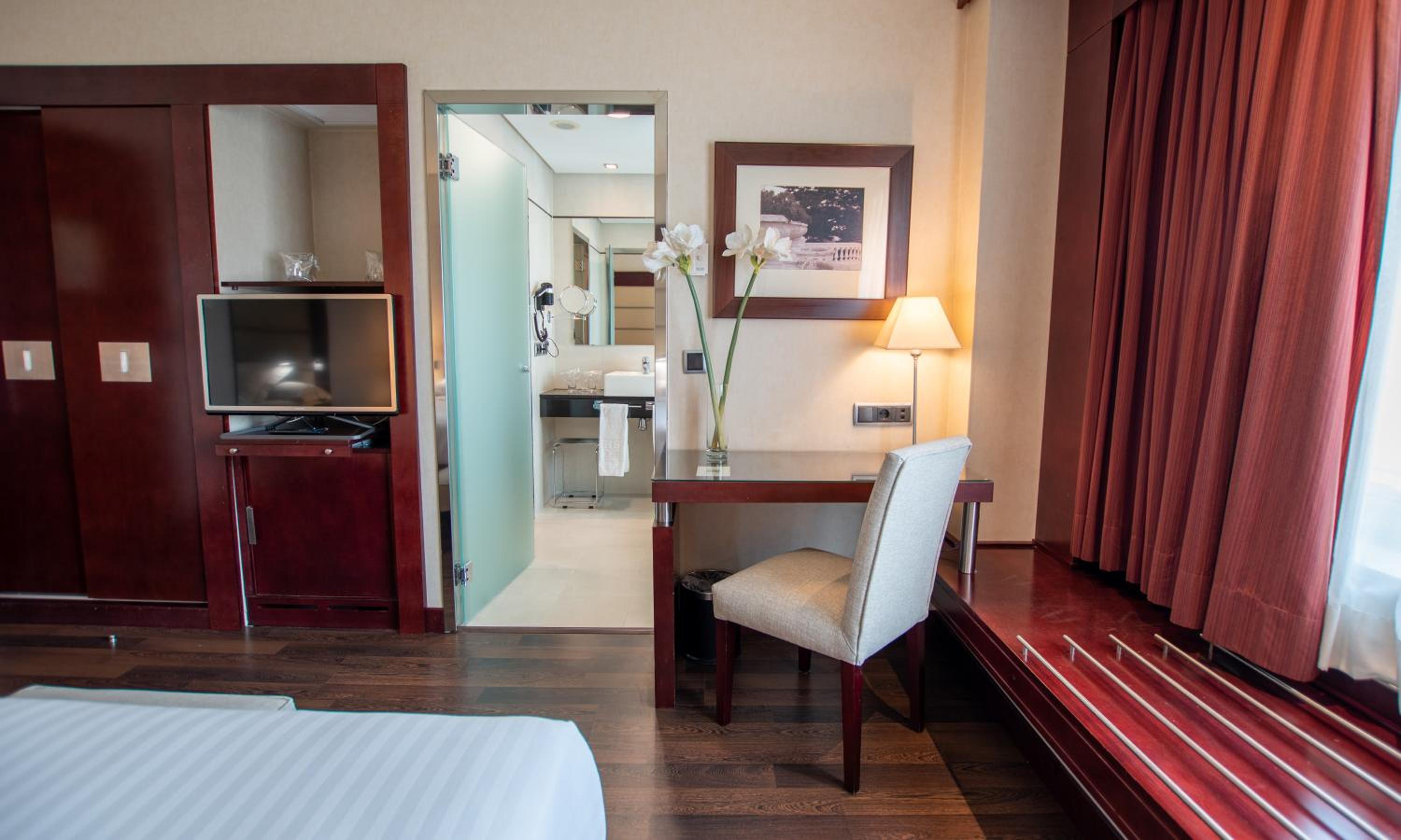 Your cozy retreat awaits in this stylish hotel room!