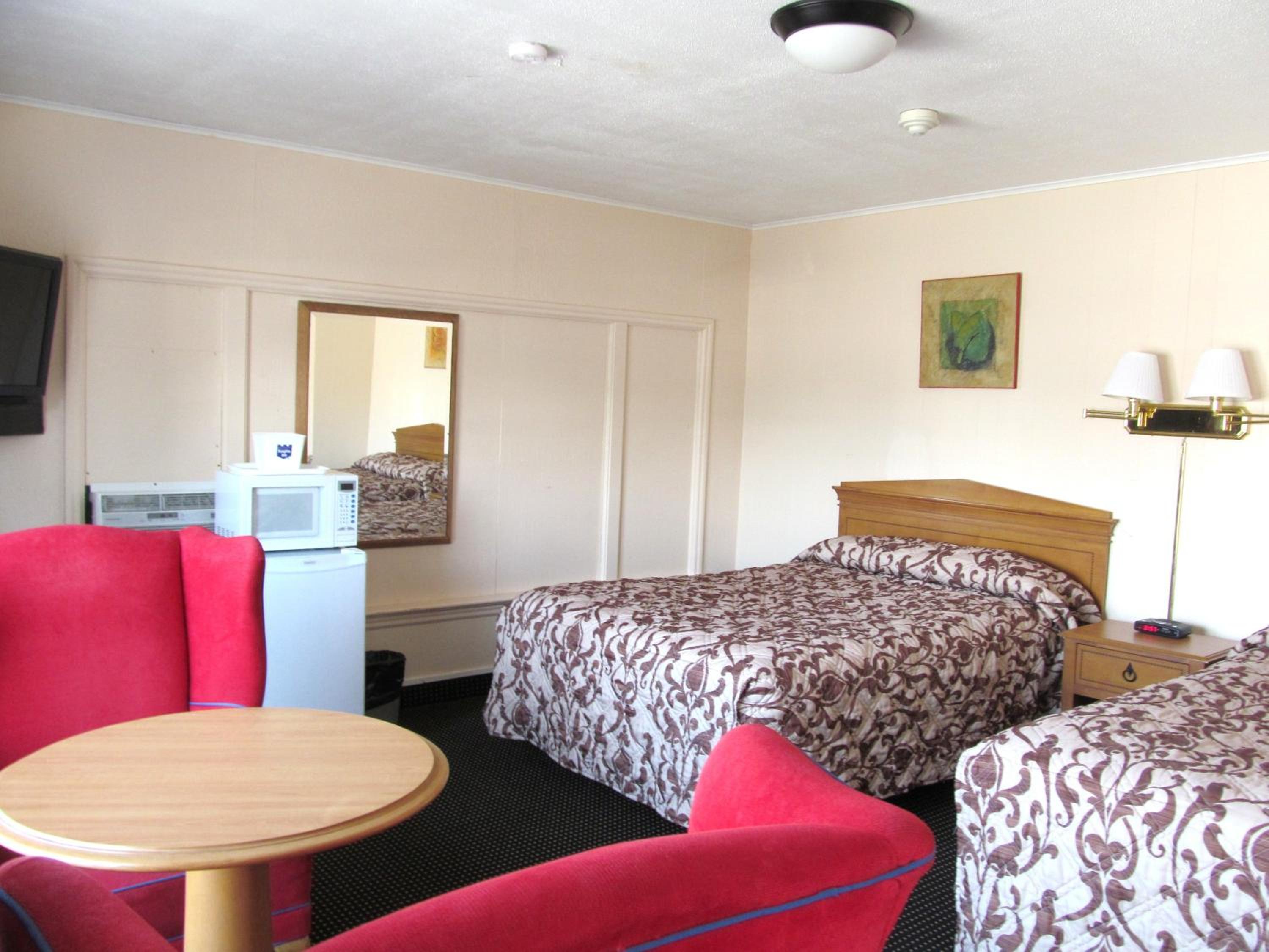 hotel room with two beds and a small kitchenette