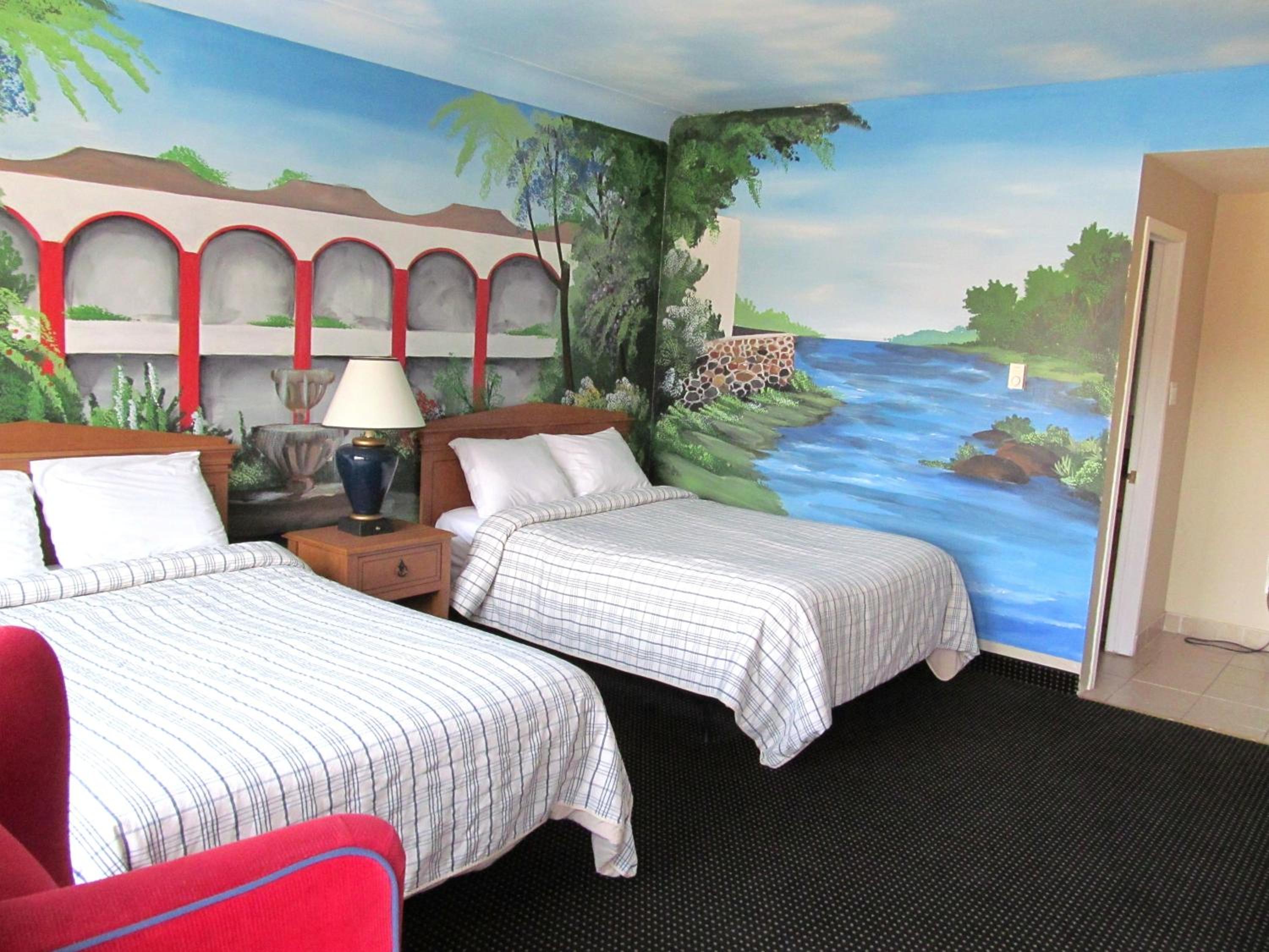room with two beds and a painting on the wall
