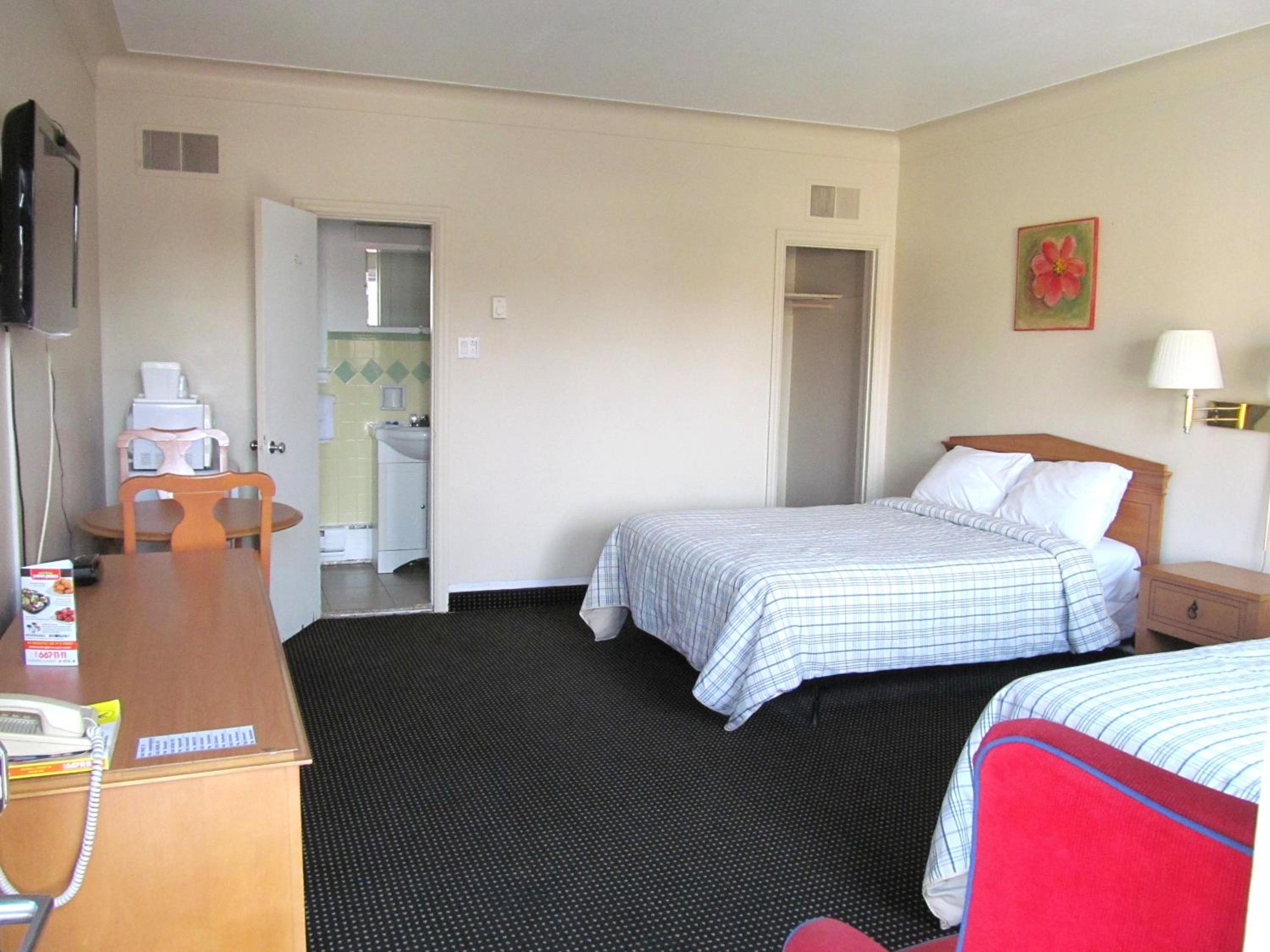 hotel room with two beds and a flat screen tv