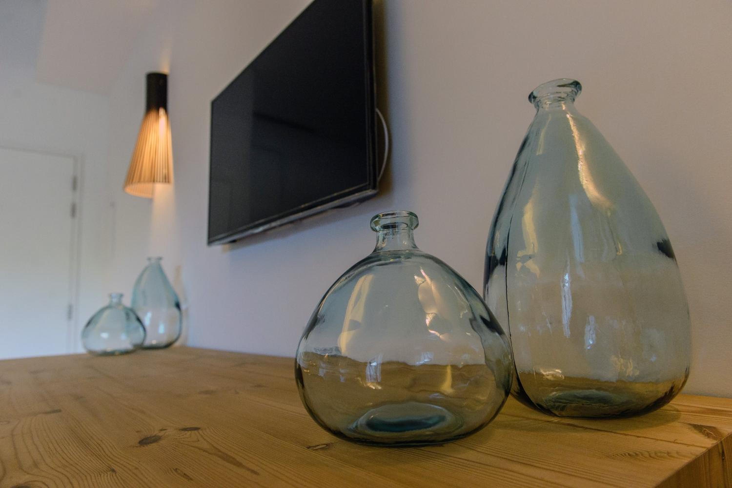 pair of glass vases sitting on a wooden table