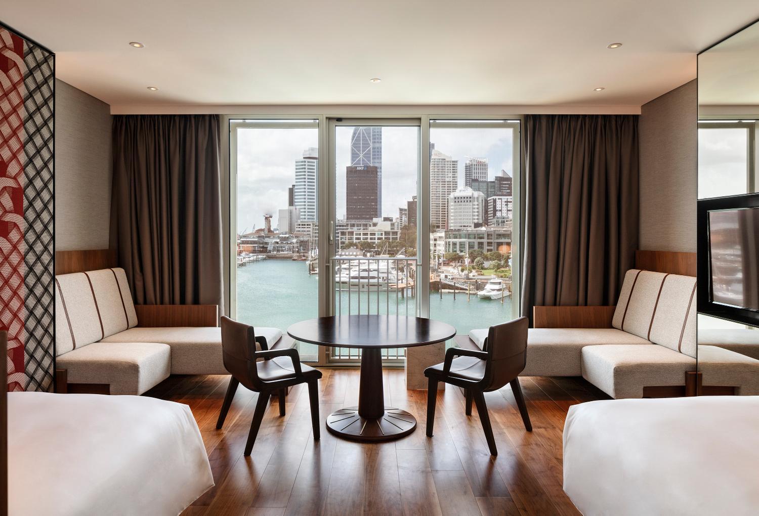 hotel room with a view of the water and city